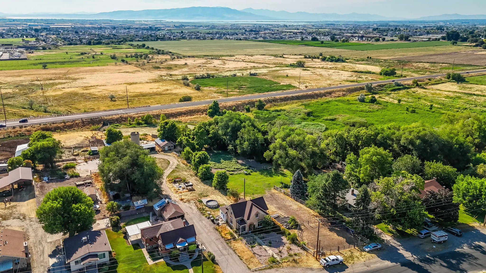 Aerial view of sparsely populated area with nearby suburban area and mountains