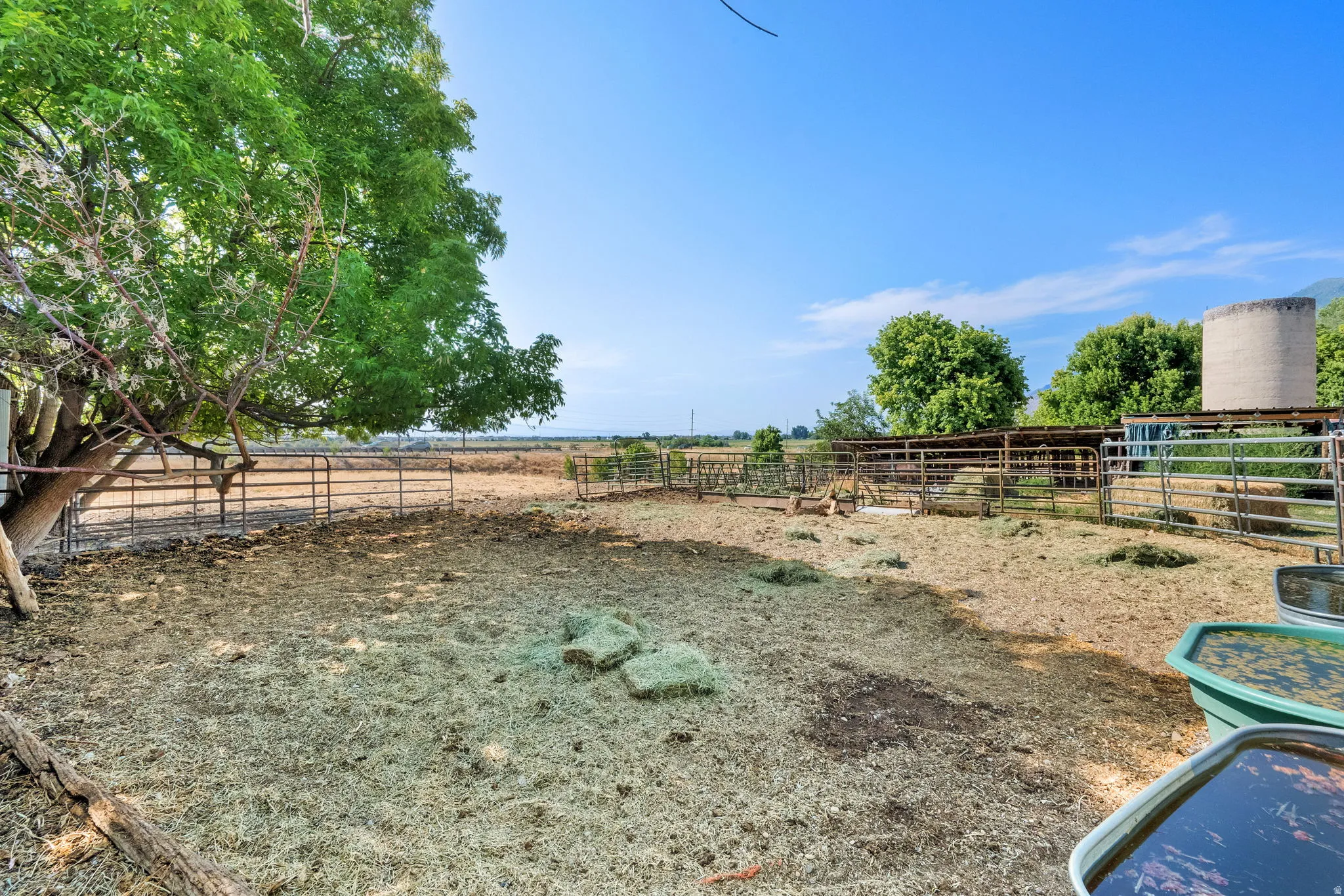 View of yard with a view of countryside, an outdoor structure, and an exterior structure