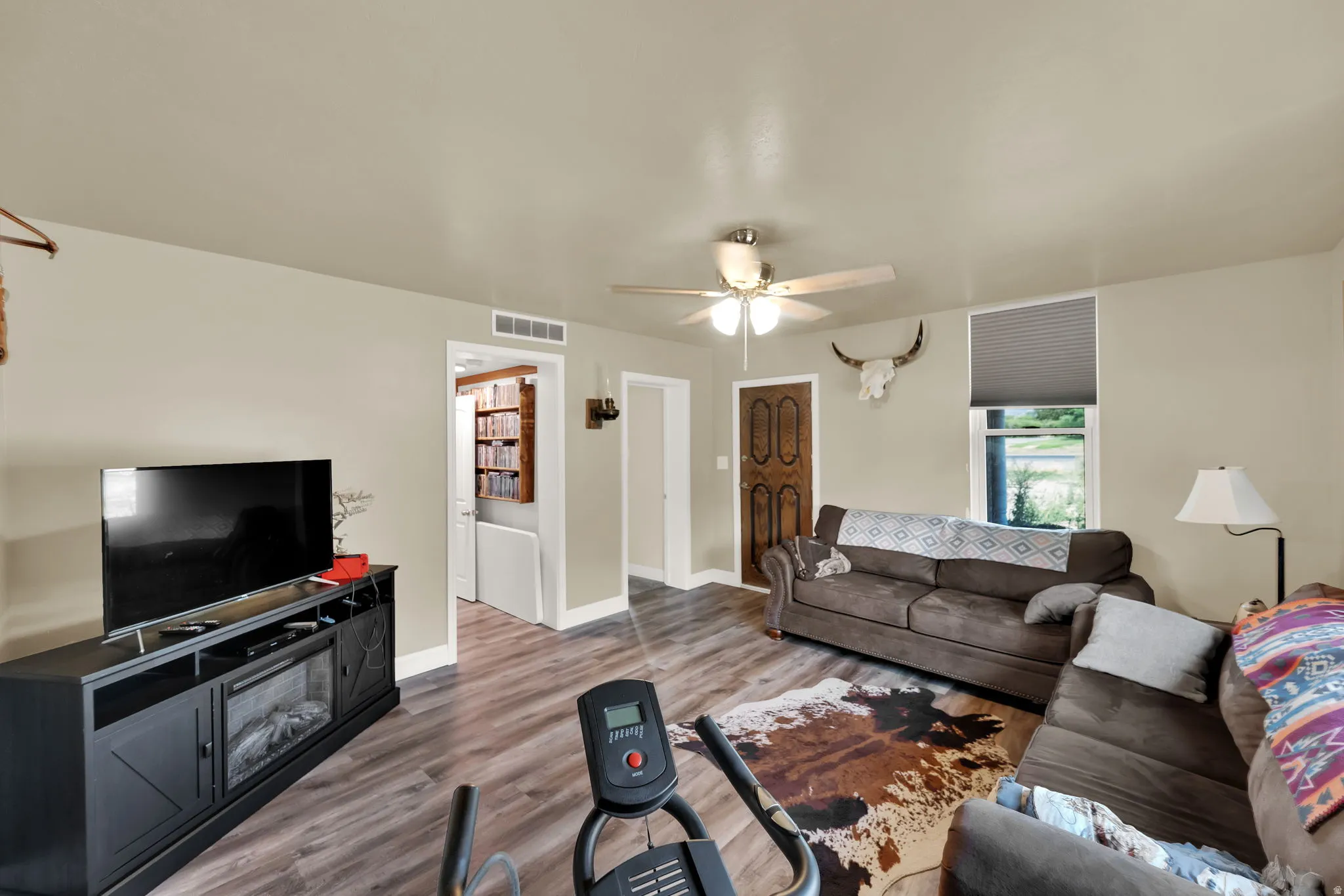 Living room featuring wood finished floors and ceiling fan