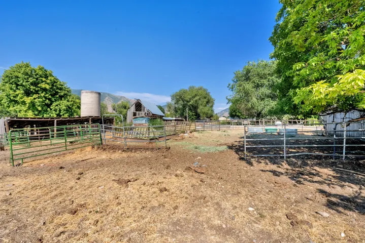 View of yard with an outbuilding, an exterior structure, and a view of rural / pastoral area