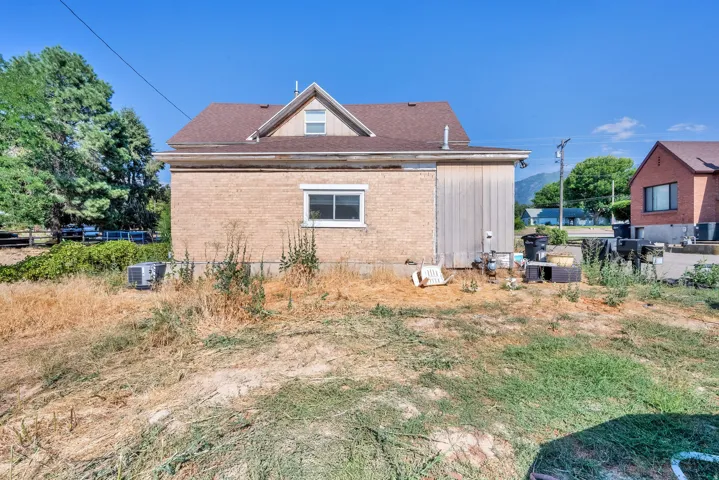View of property exterior featuring brick siding and a cooling unit