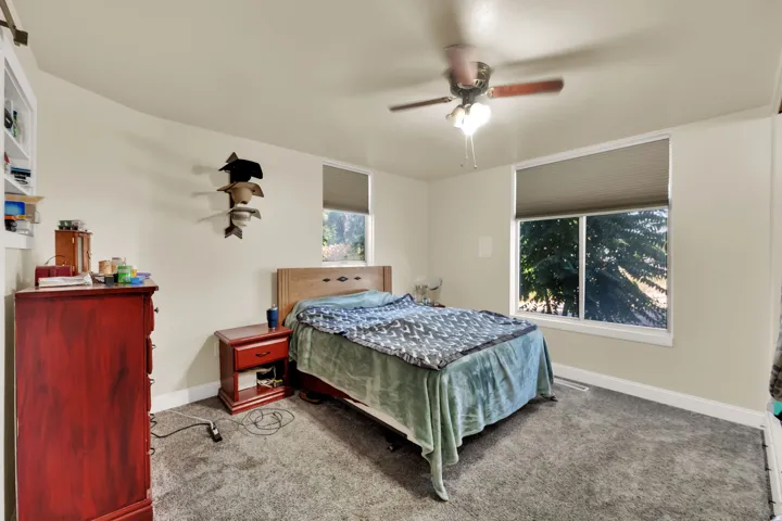 Bedroom with carpet and ceiling fan
