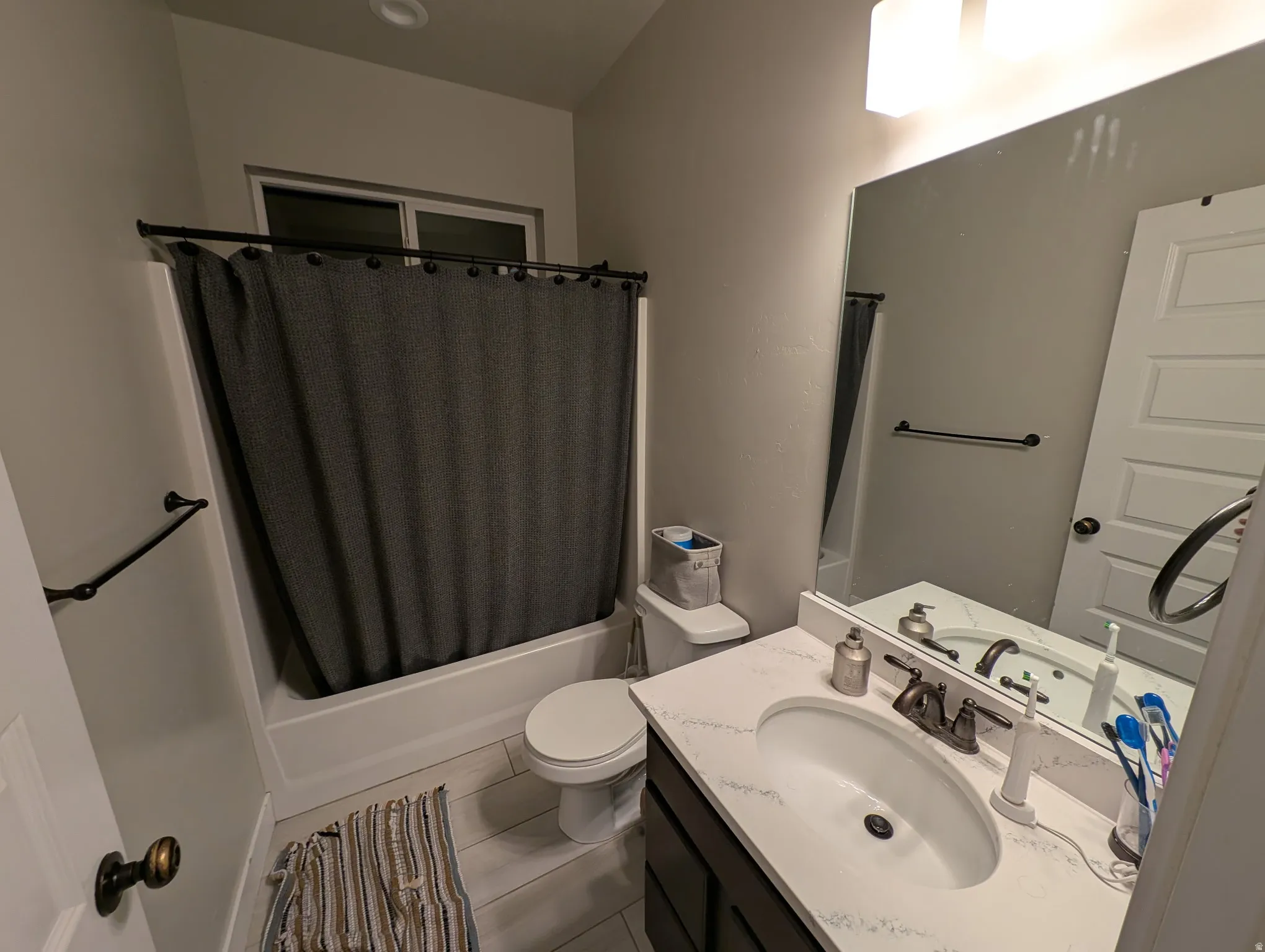 Bathroom with vanity and shower / bath combo with shower curtain