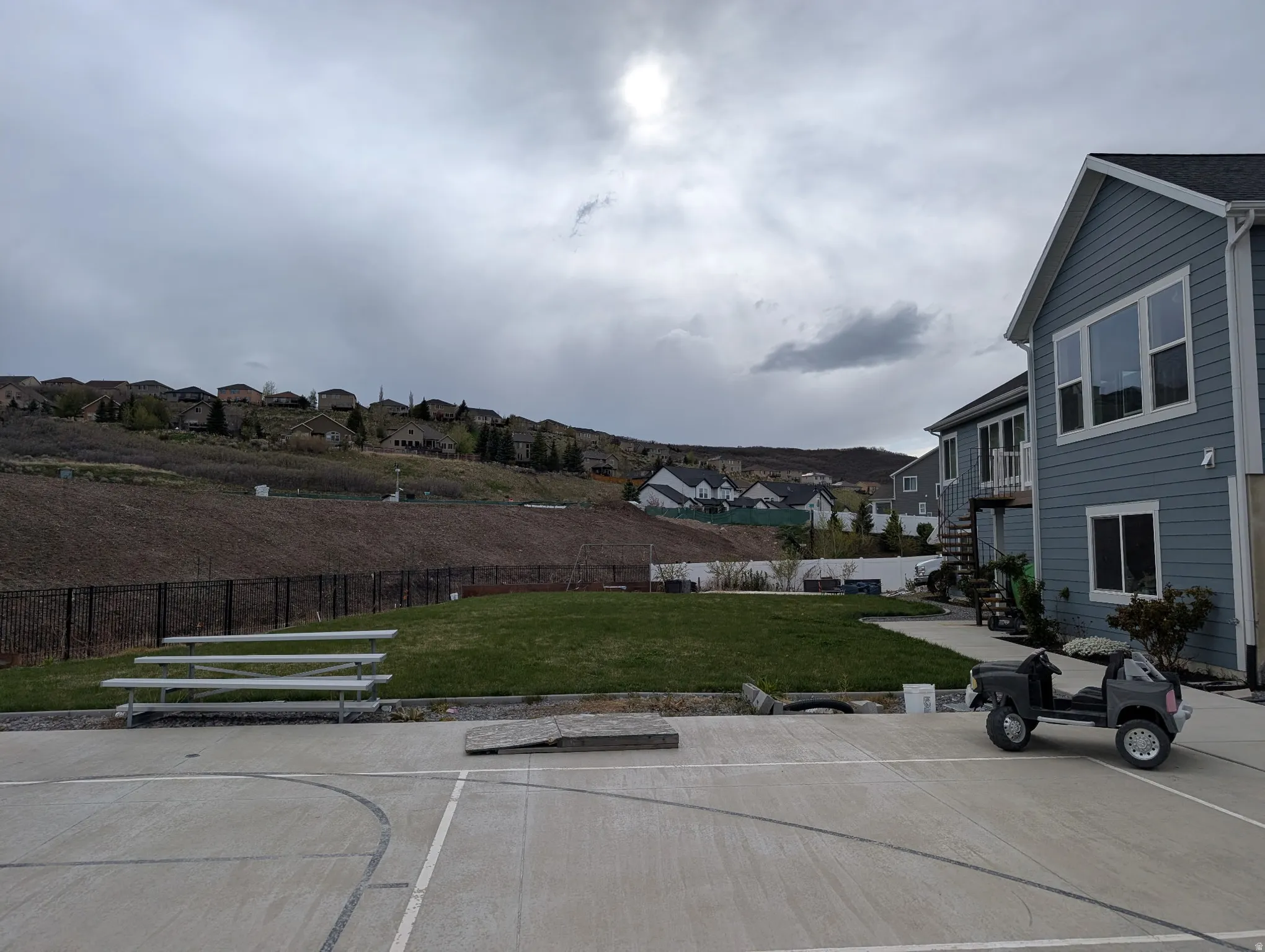 Exterior space with a residential view, a fenced backyard, and a deck
