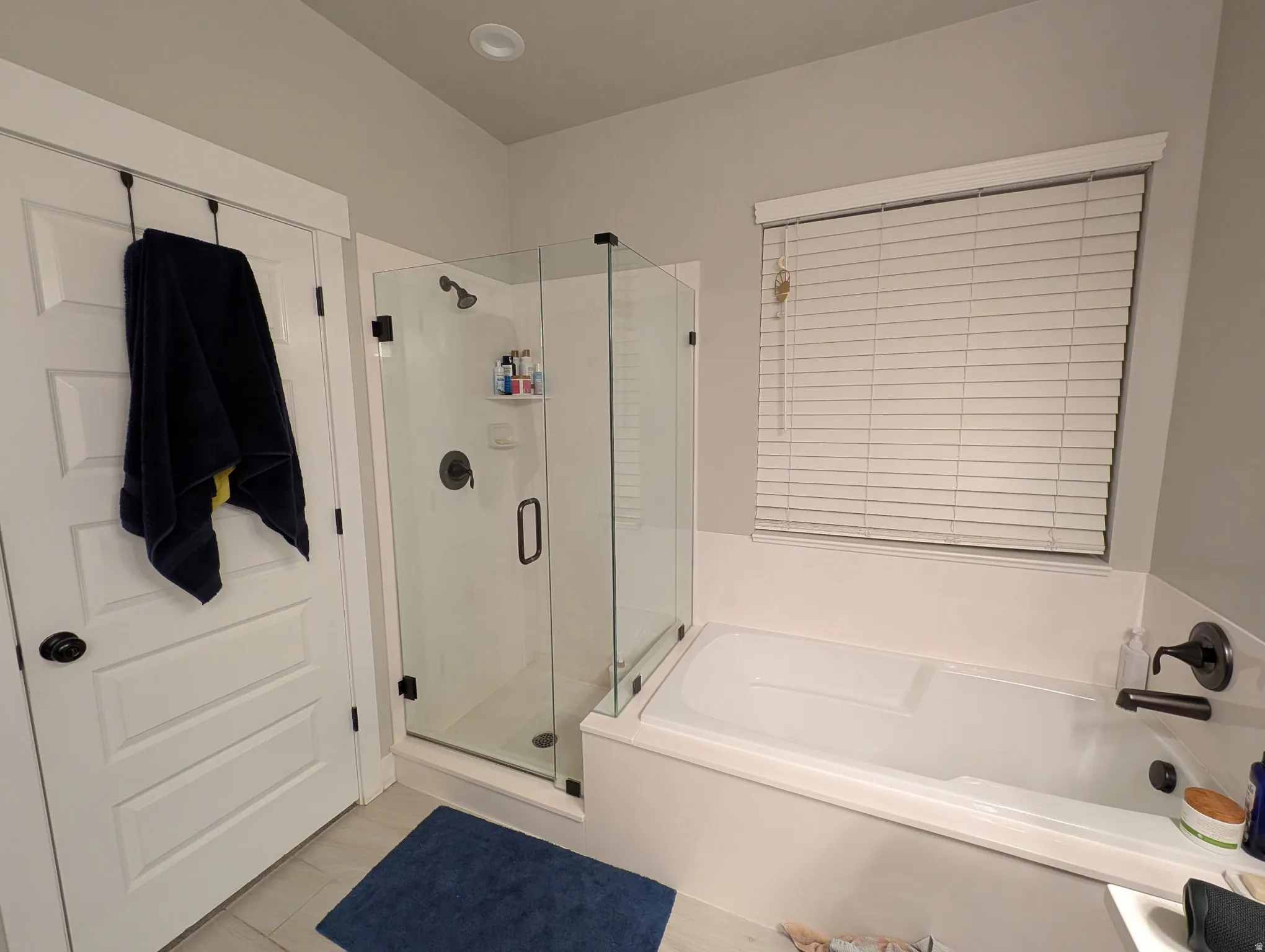 Bathroom featuring a shower stall and a garden tub