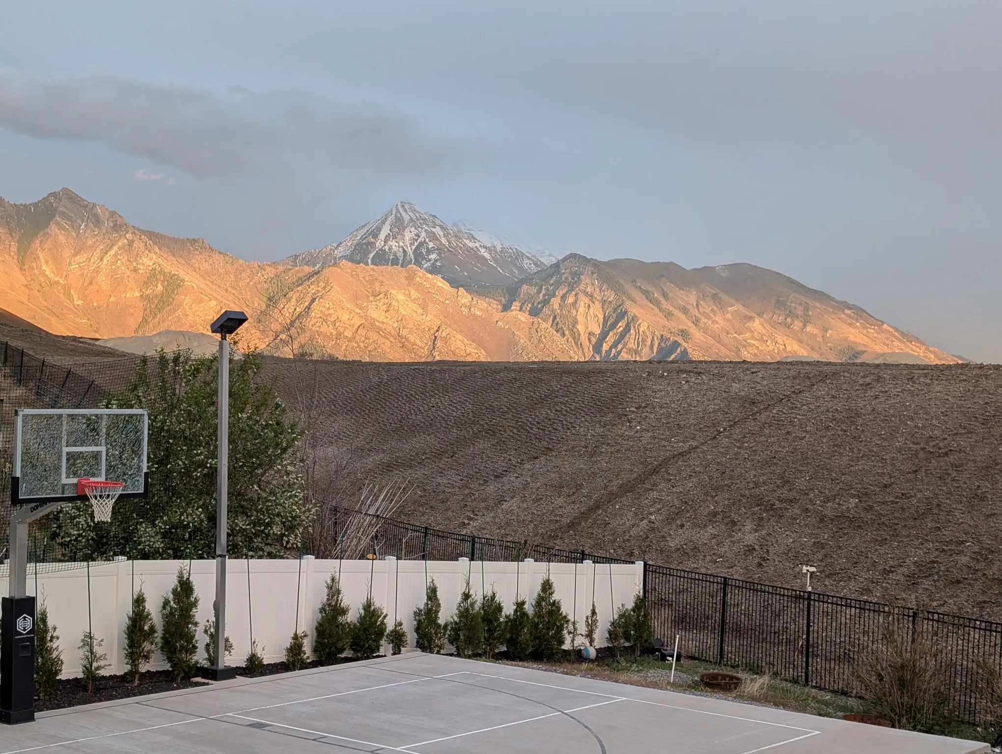 View of basketball court with a mountain view and basketball hoop