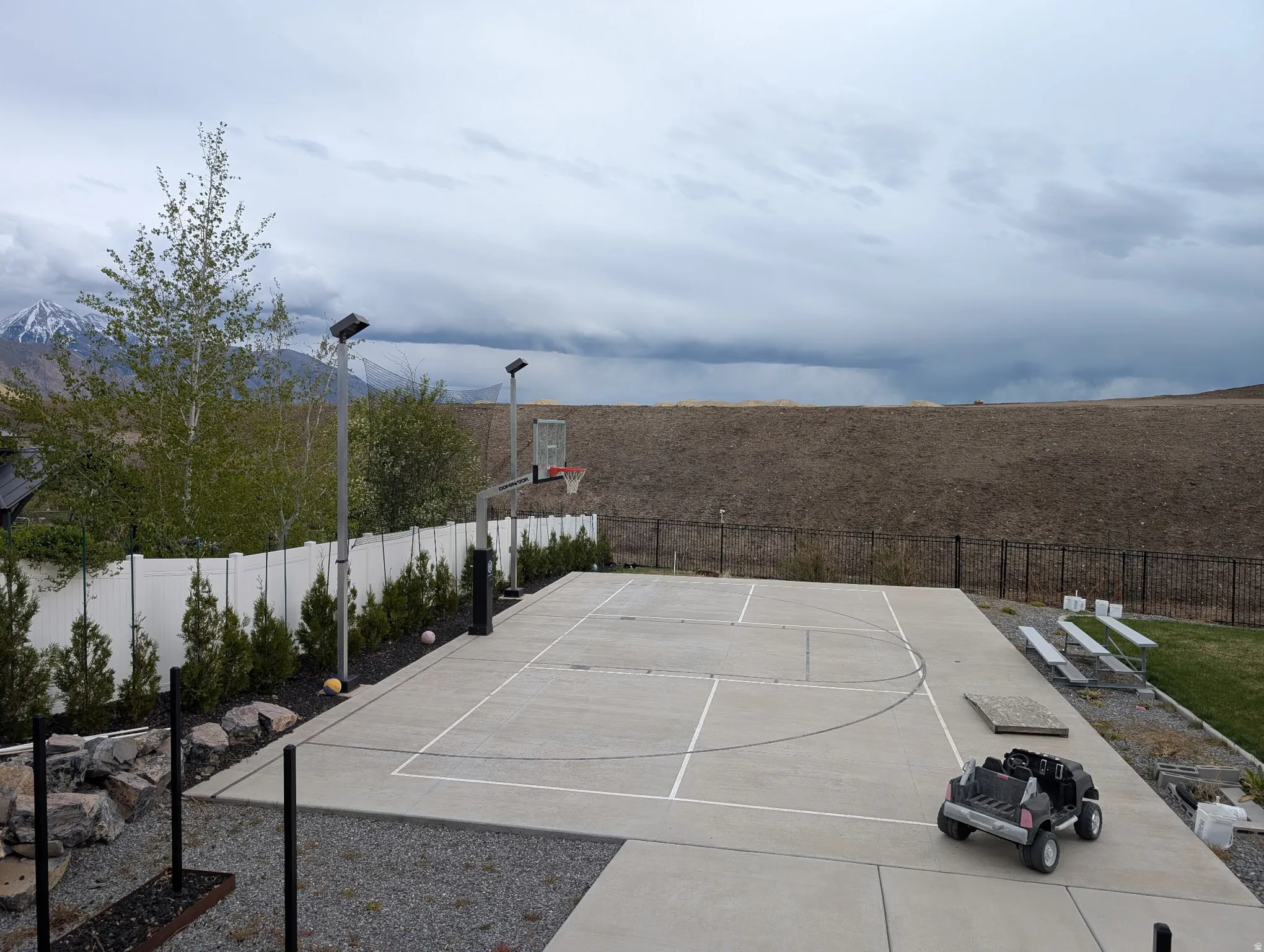 View of sport court featuring basketball hoop and a mountain view
