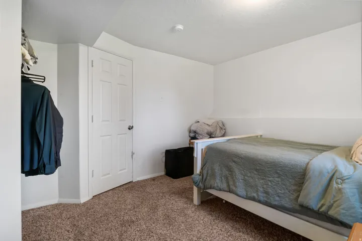 Bedroom featuring carpet flooring, and a textured ceiling