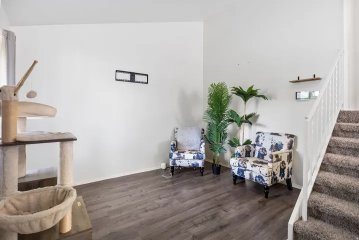 Sitting room featuring stairs and dark wood-type flooring
