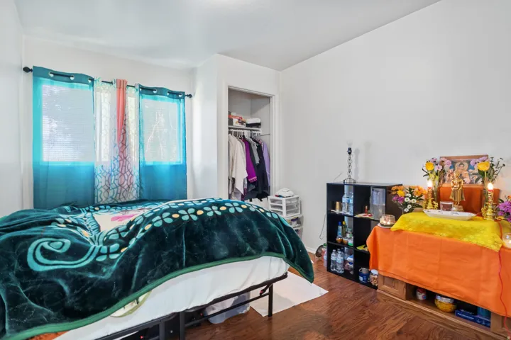 Bedroom with a closet and wood finished floors