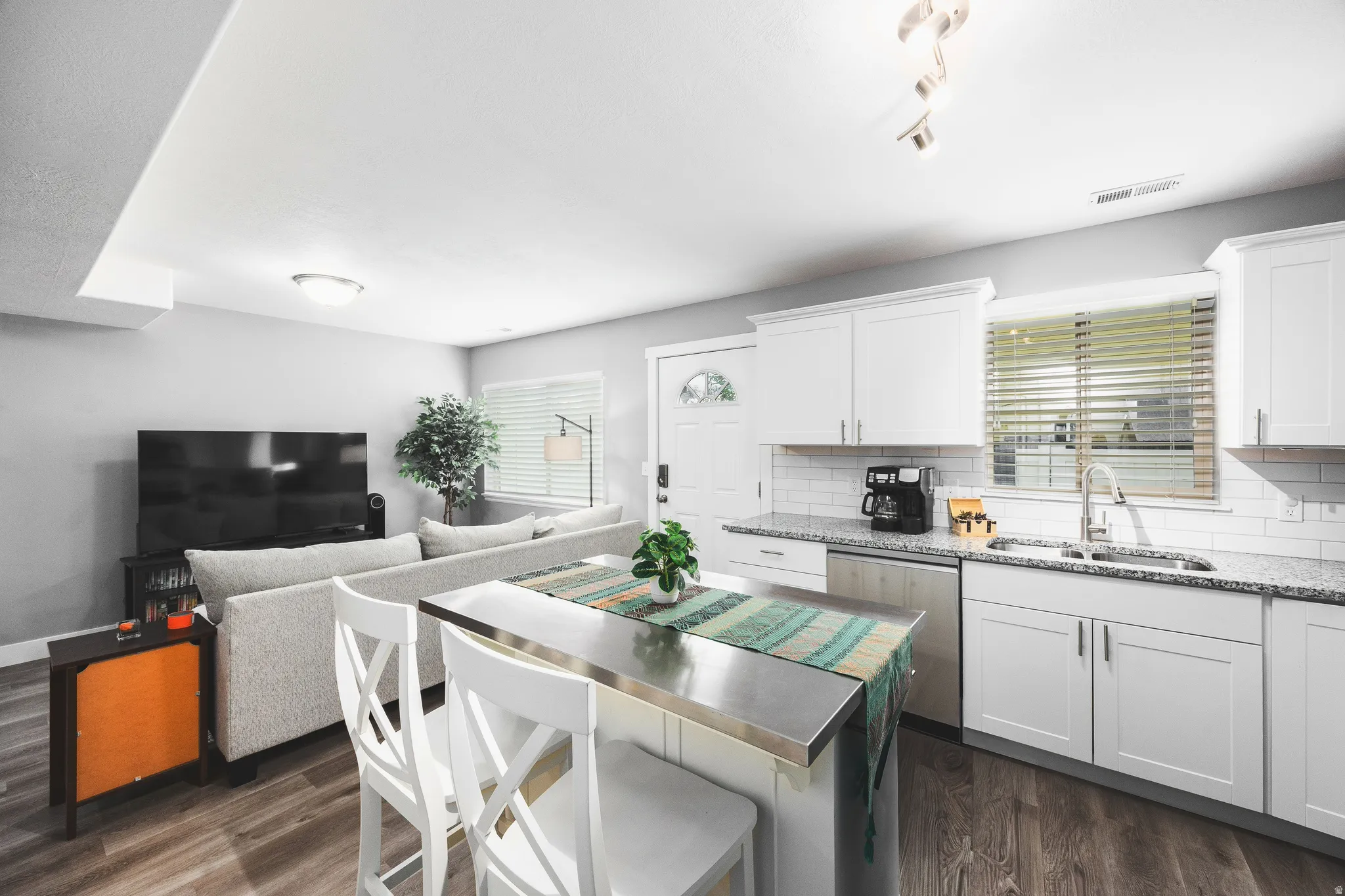 Kitchen featuring stainless steel dishwasher and kitchen island