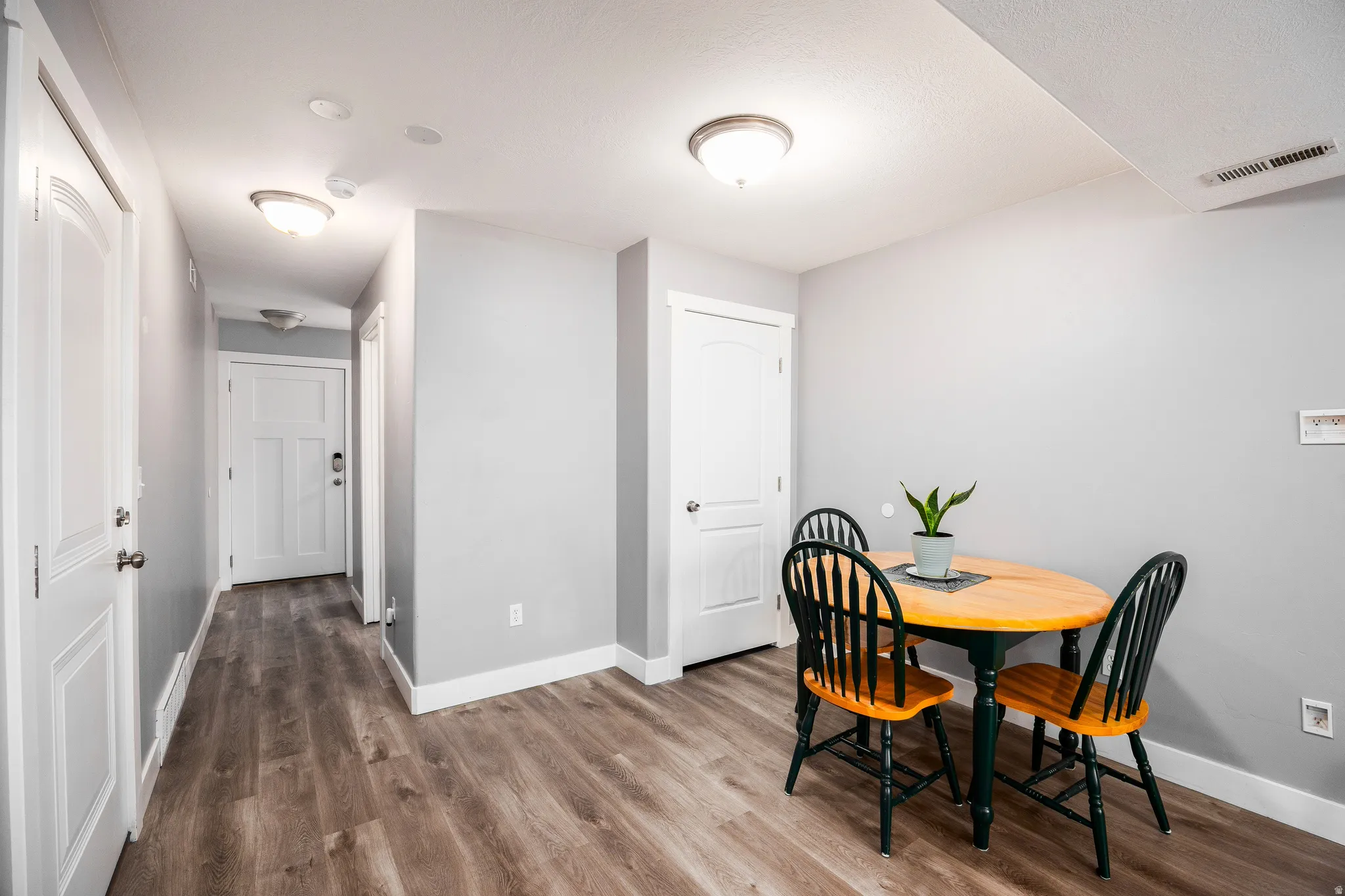 Entryway, hall, dining space with baseboards and LVP floors
