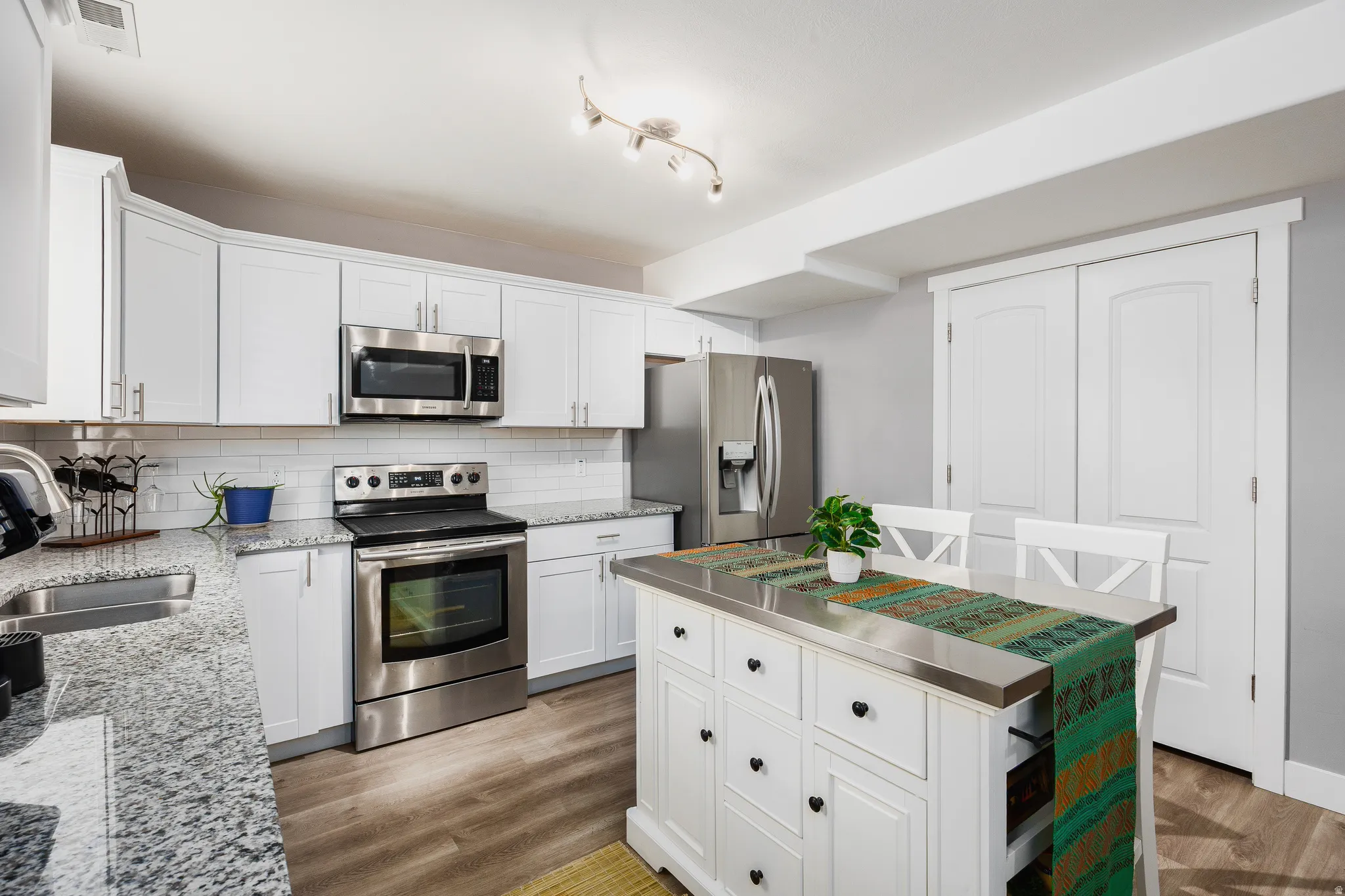 Kitchen featuring stainless appliances, island, and spacious pantry