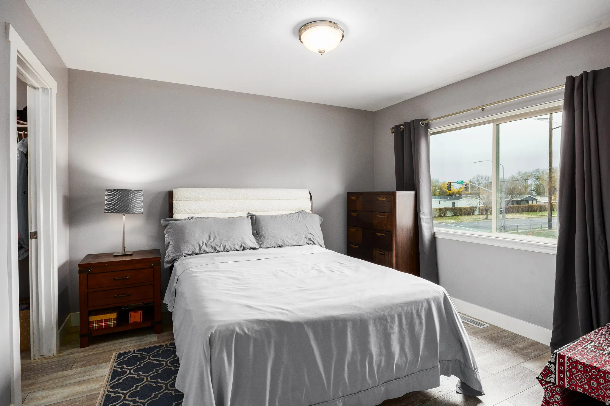 Primary suite upstairs featuring large window and LVP flooring