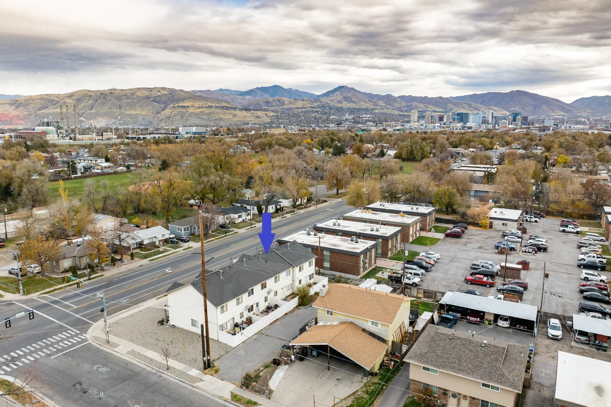 Aerial view of back of house and extra parking, featuring proximity to park, central downtown, and mountains