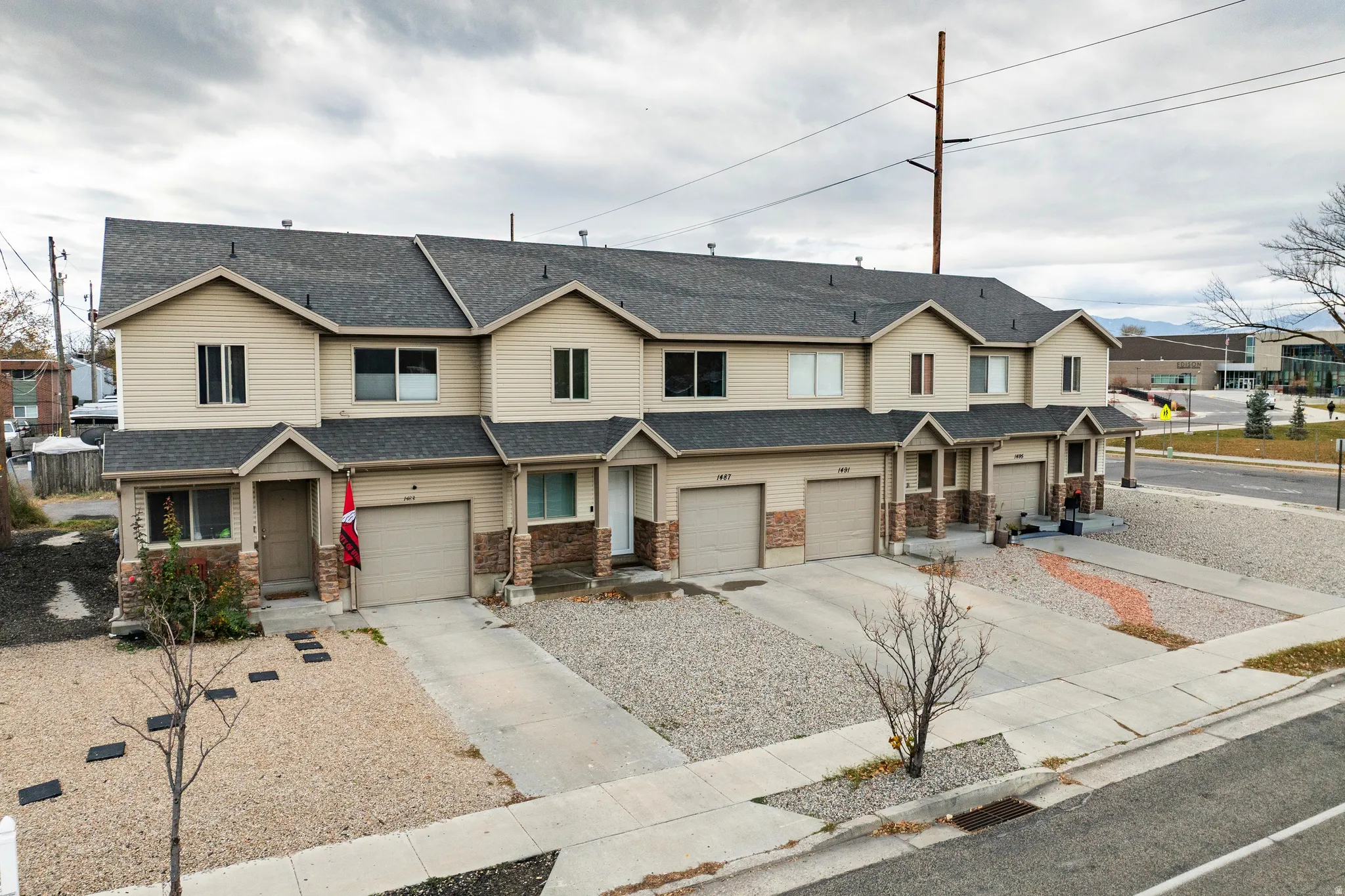 View of four attached townhomes in complex with great neighbors.