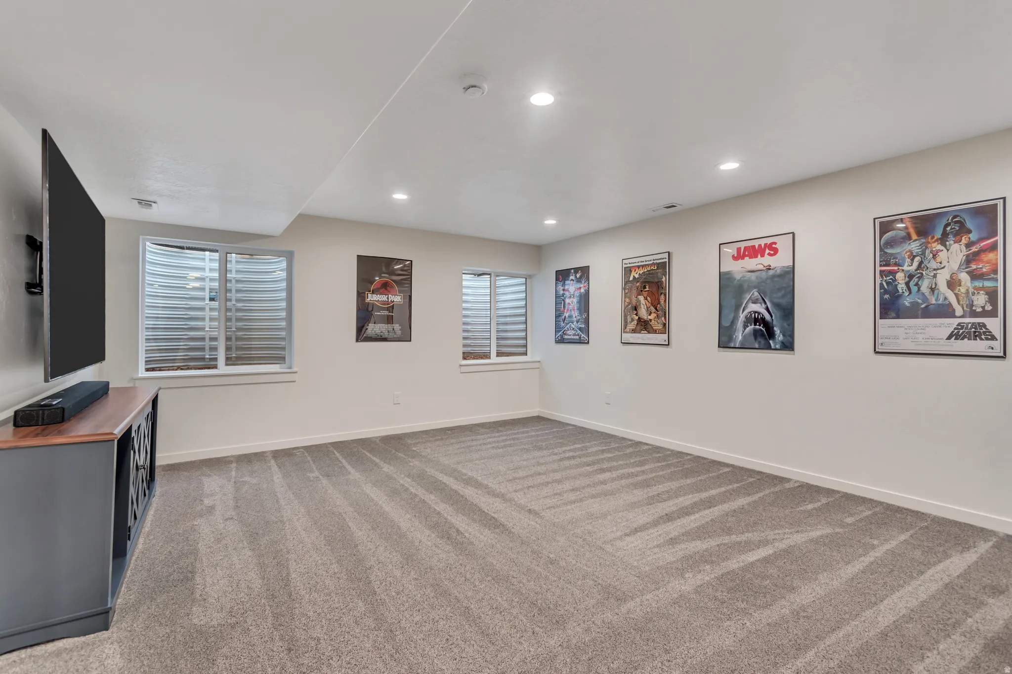 Inviting family room featuring light colored carpet and recessed lighting