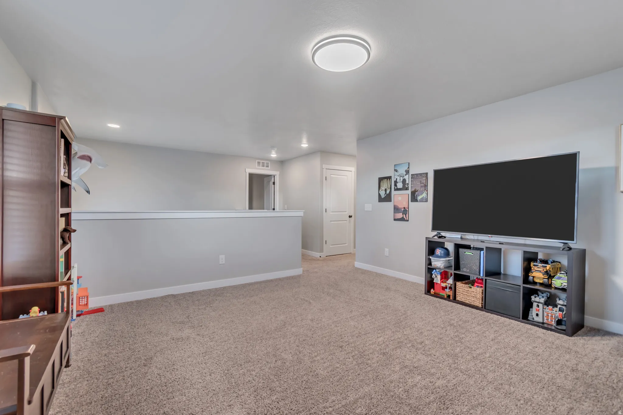 Spacious upstairs loft—ideal for a playroom, home office, or cozy TV/game room.