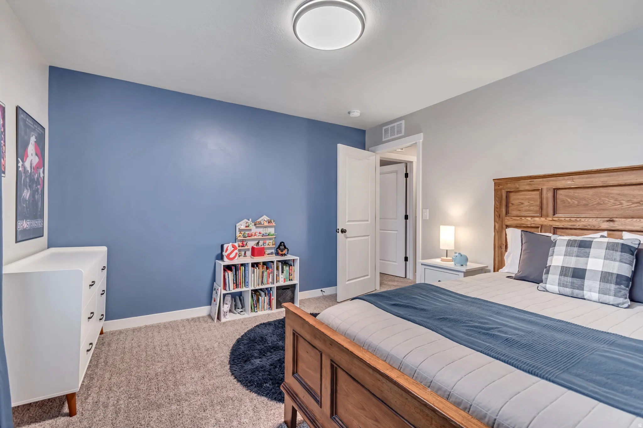 Bedroom featuring baseboards and light carpet