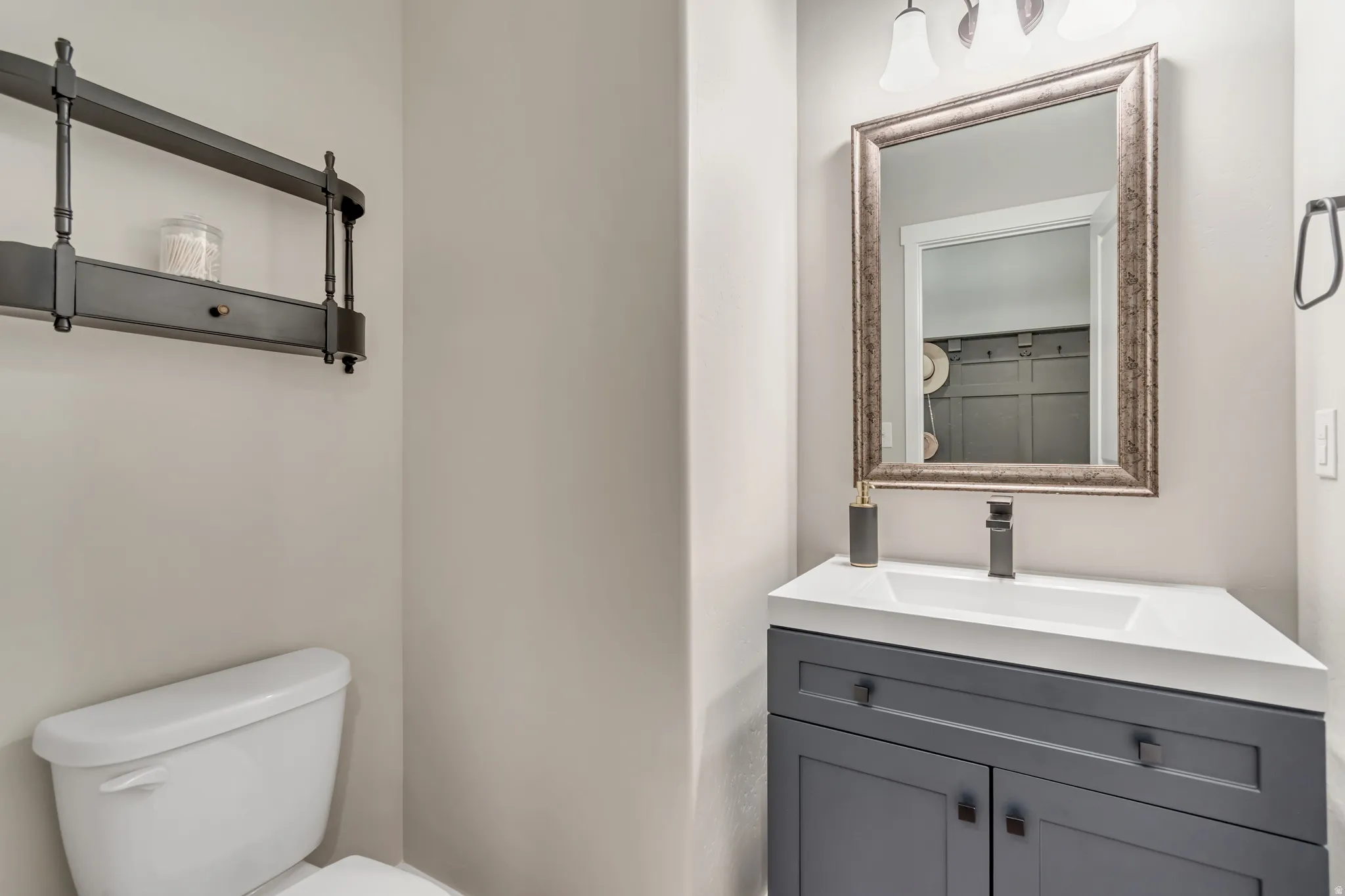 Half bathroom with vanity and toilet