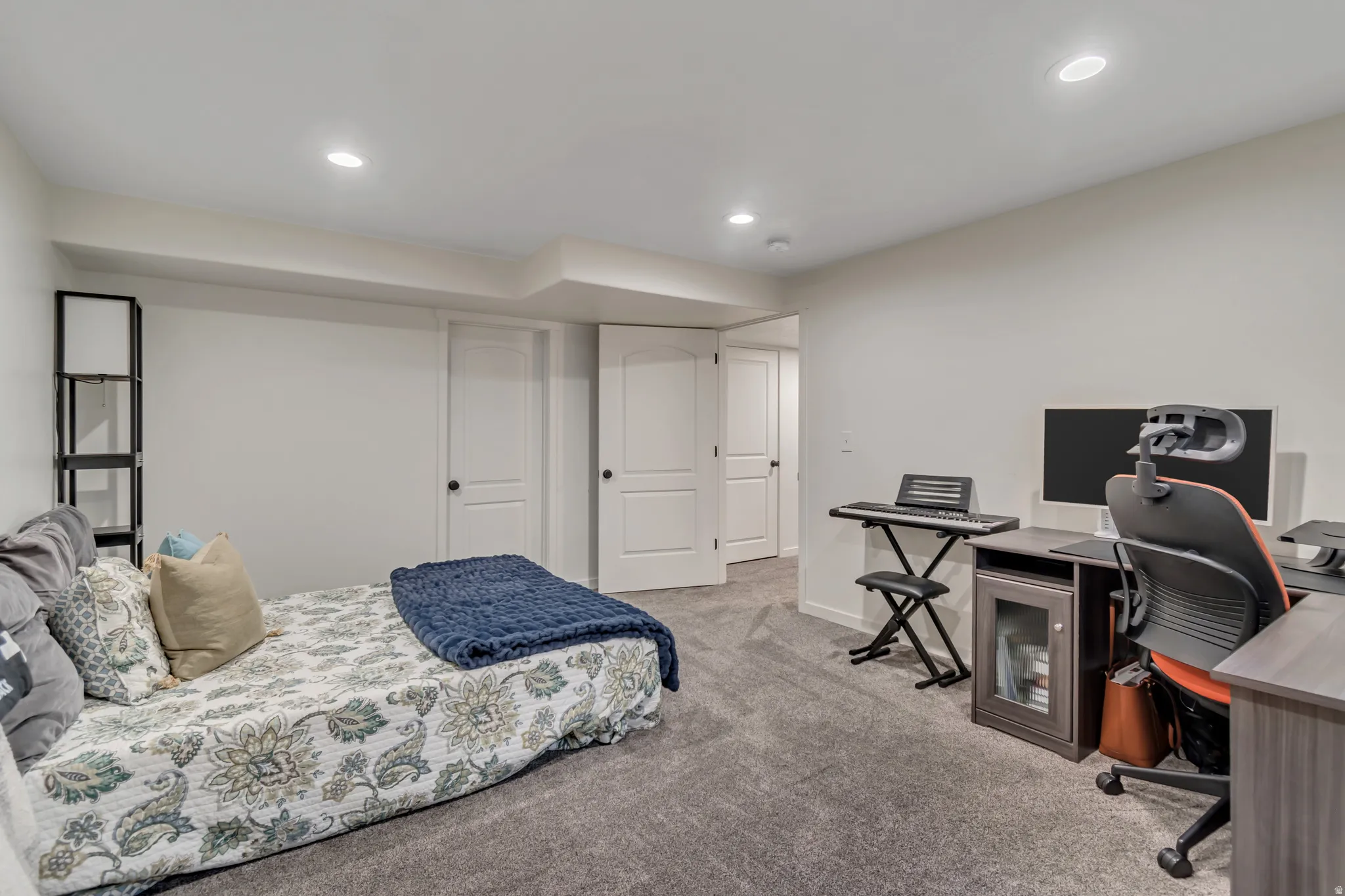 Bedroom featuring a desk, light carpet, and recessed lighting