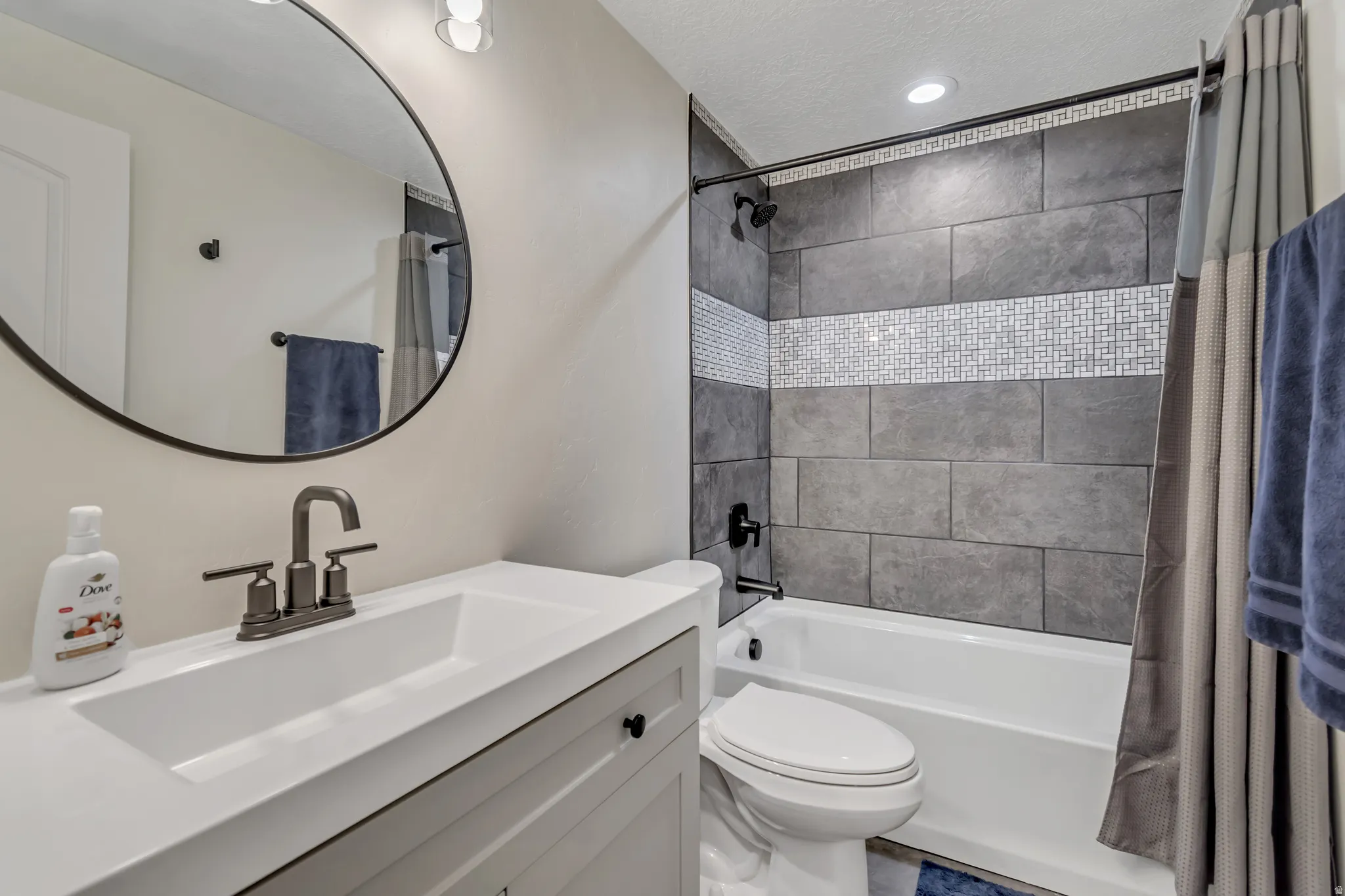 Bathroom with vanity, shower / tub combo