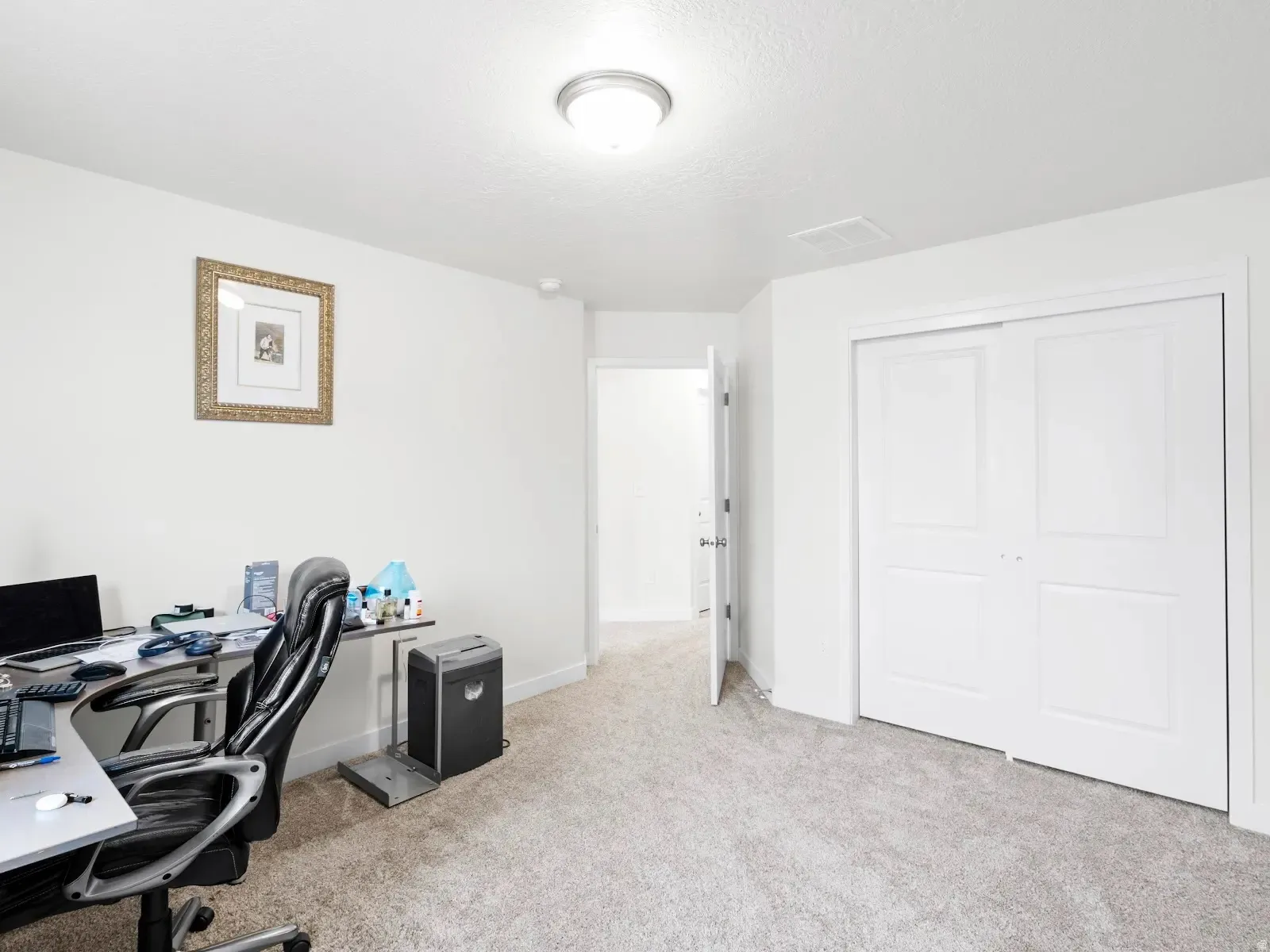 Office featuring light carpet and baseboards