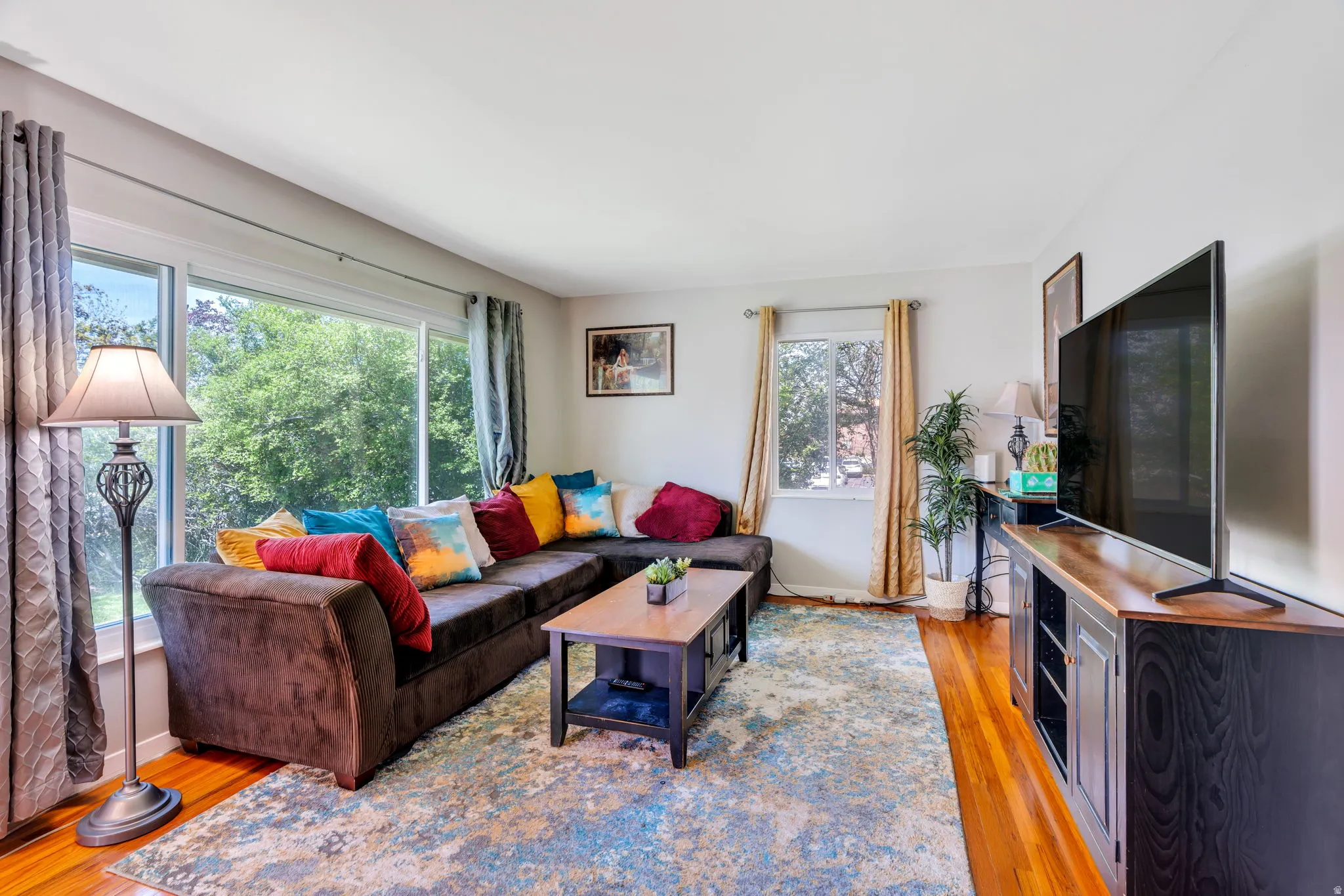 Living area with light wood-style flooring and baseboards
