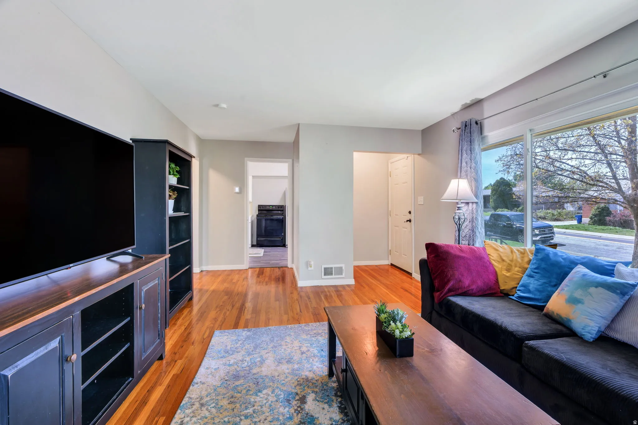 Living room with light wood-style flooring and baseboards