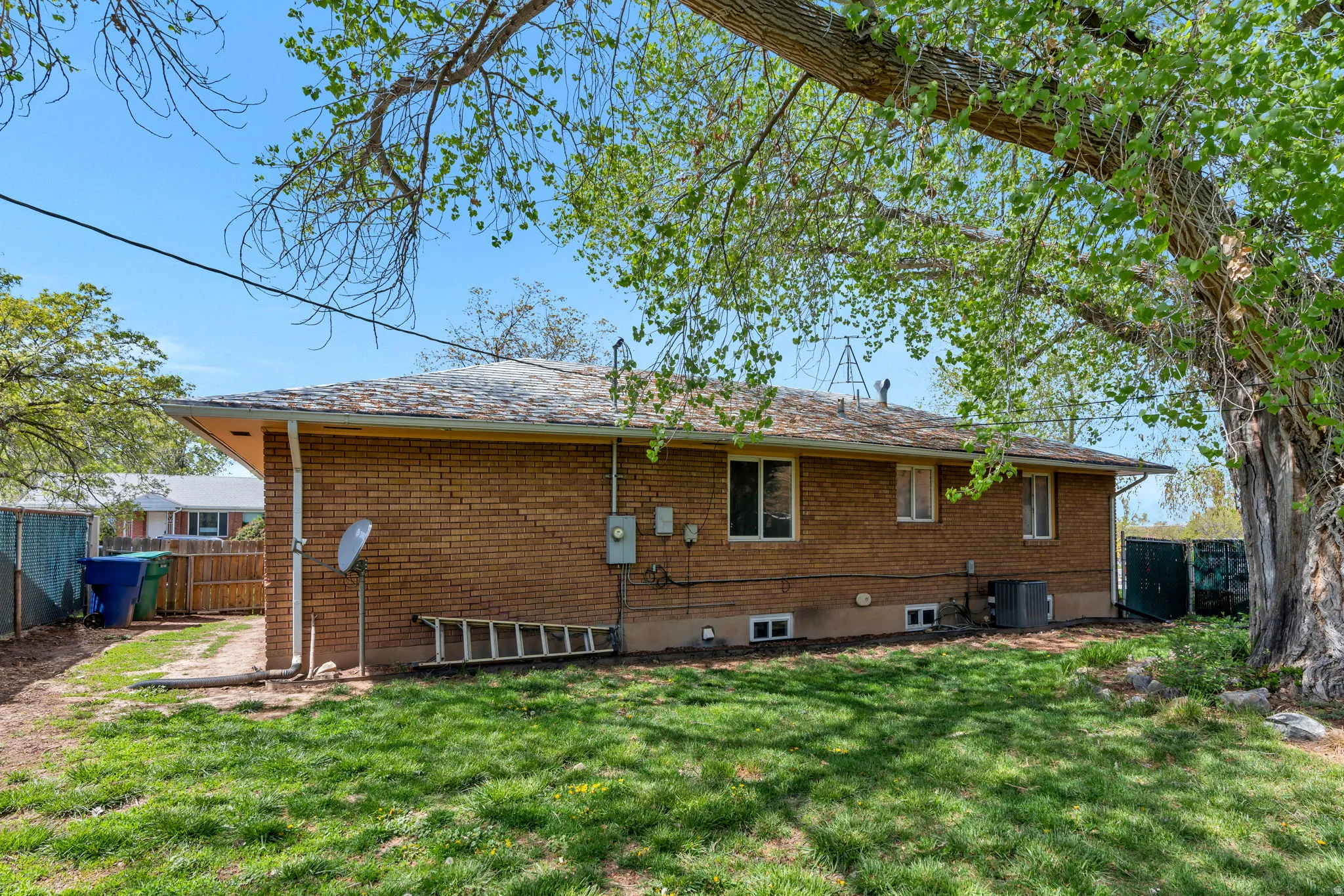 Rear view of property with brick siding