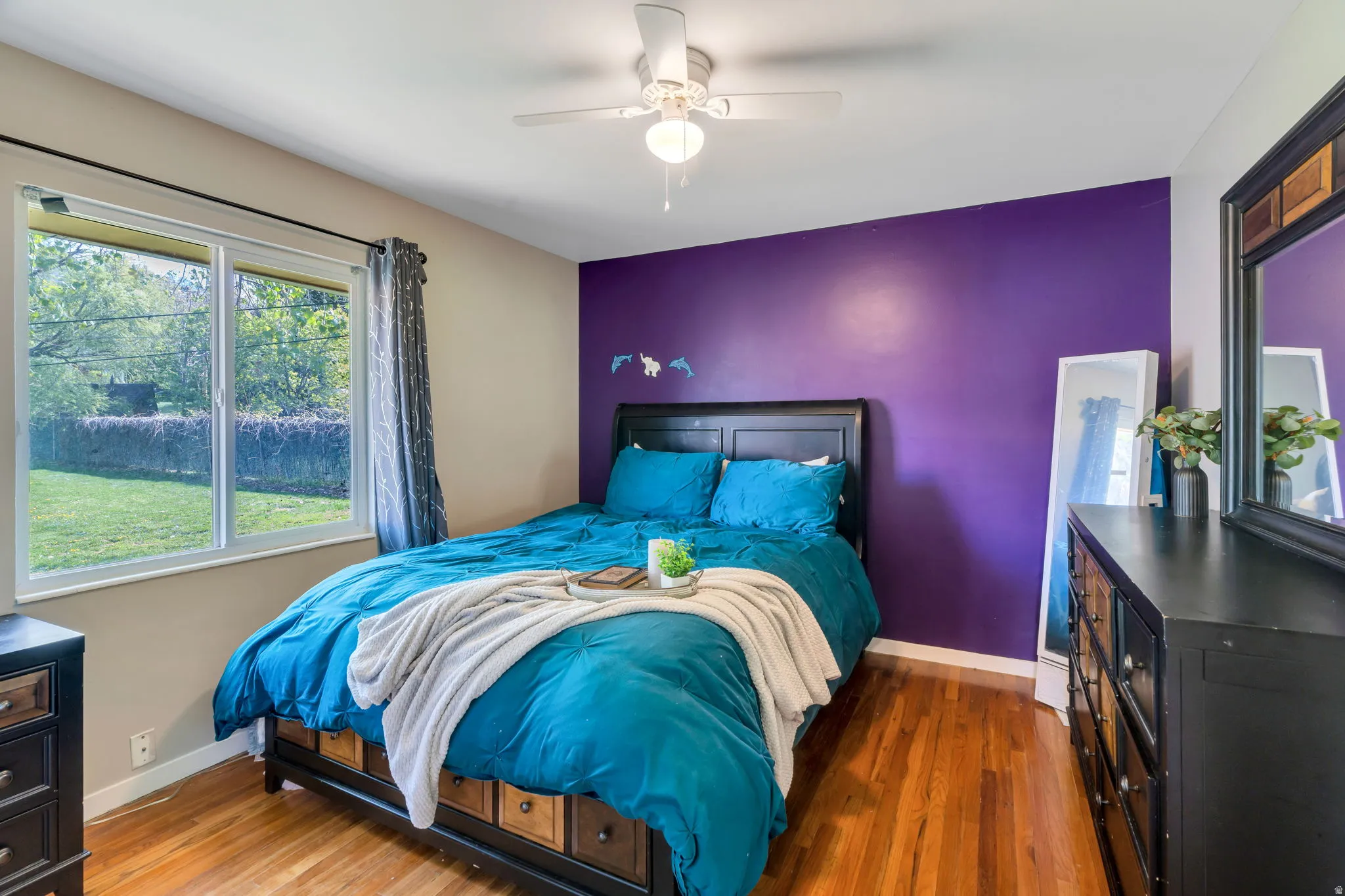 Bedroom with dark wood finished floors and ceiling fan