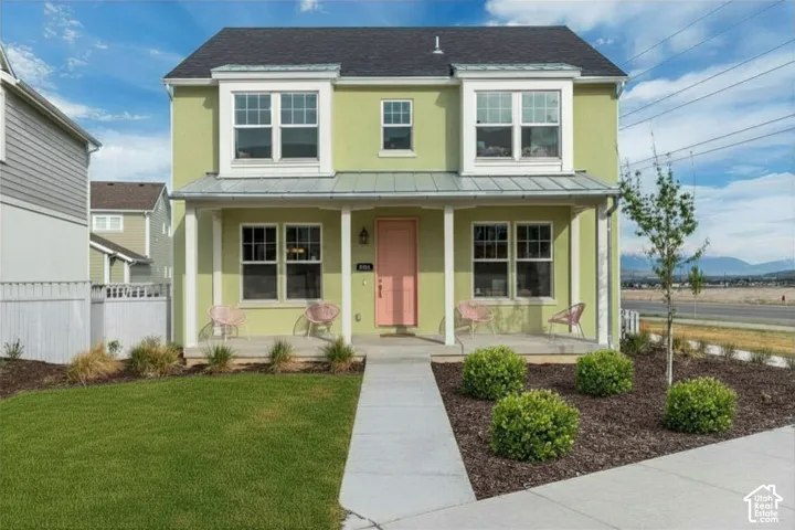 Stucco exterior with a metal-accented front porch