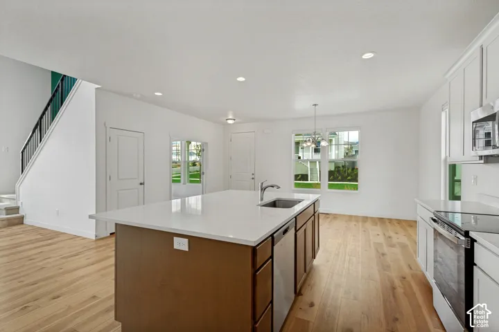 Kitchen island with an undermount sink and stainless steel dishwasher