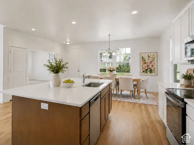 Expansive kitchen island with a built-in sink and white countertop, stainless steel appliance, REFRIGERATOR included, AI staged