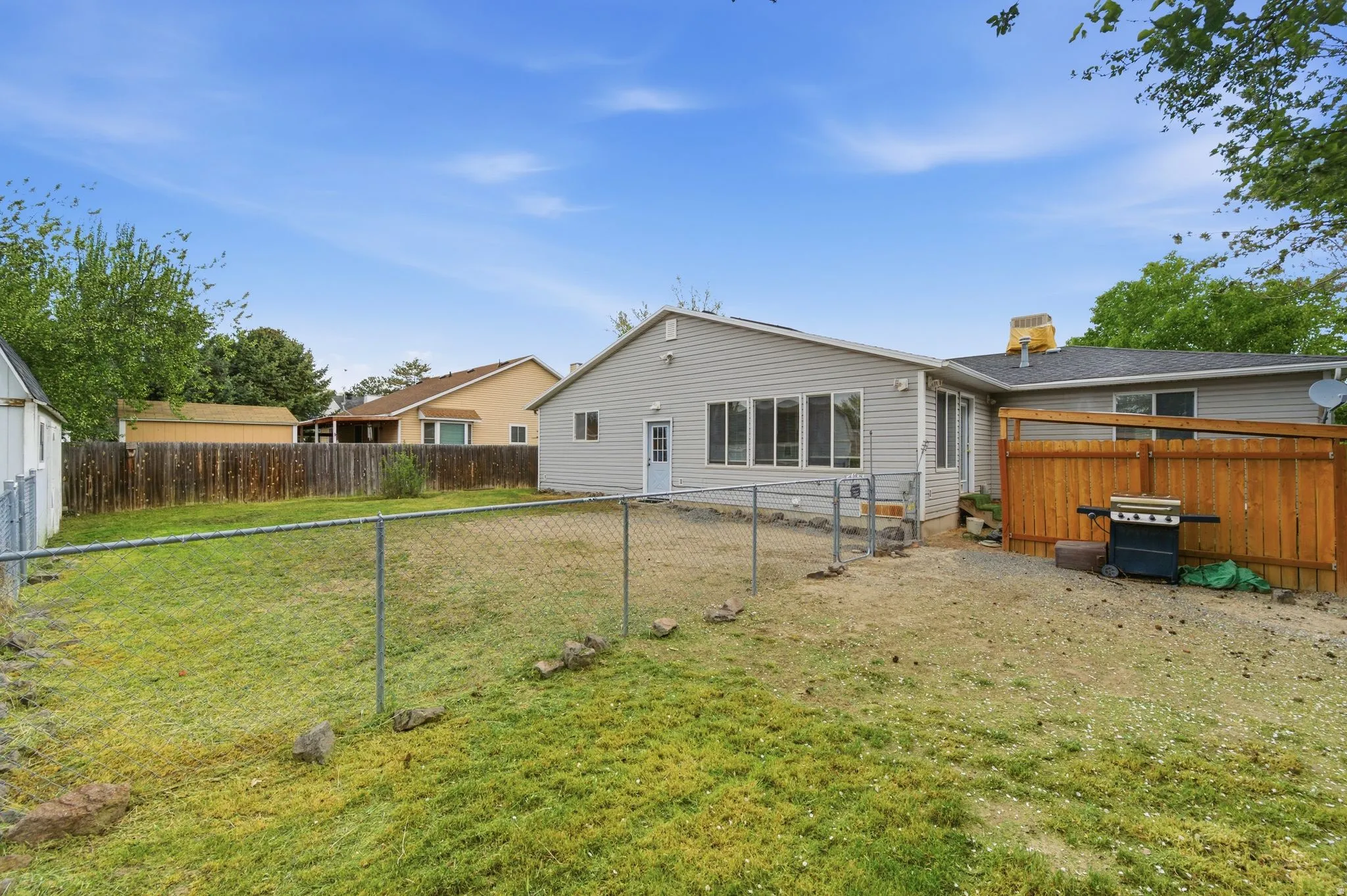 Back of house with a fenced backyard