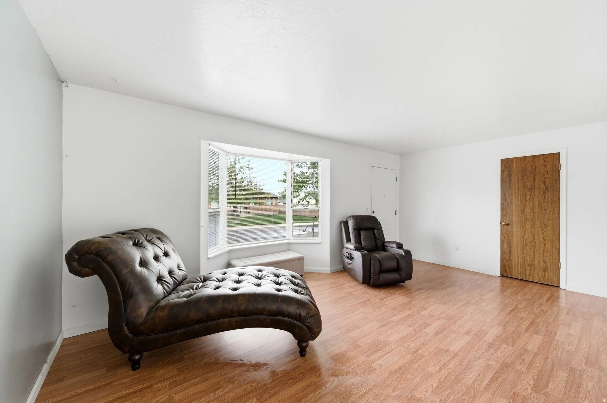 Living area with wood finished floors and baseboards