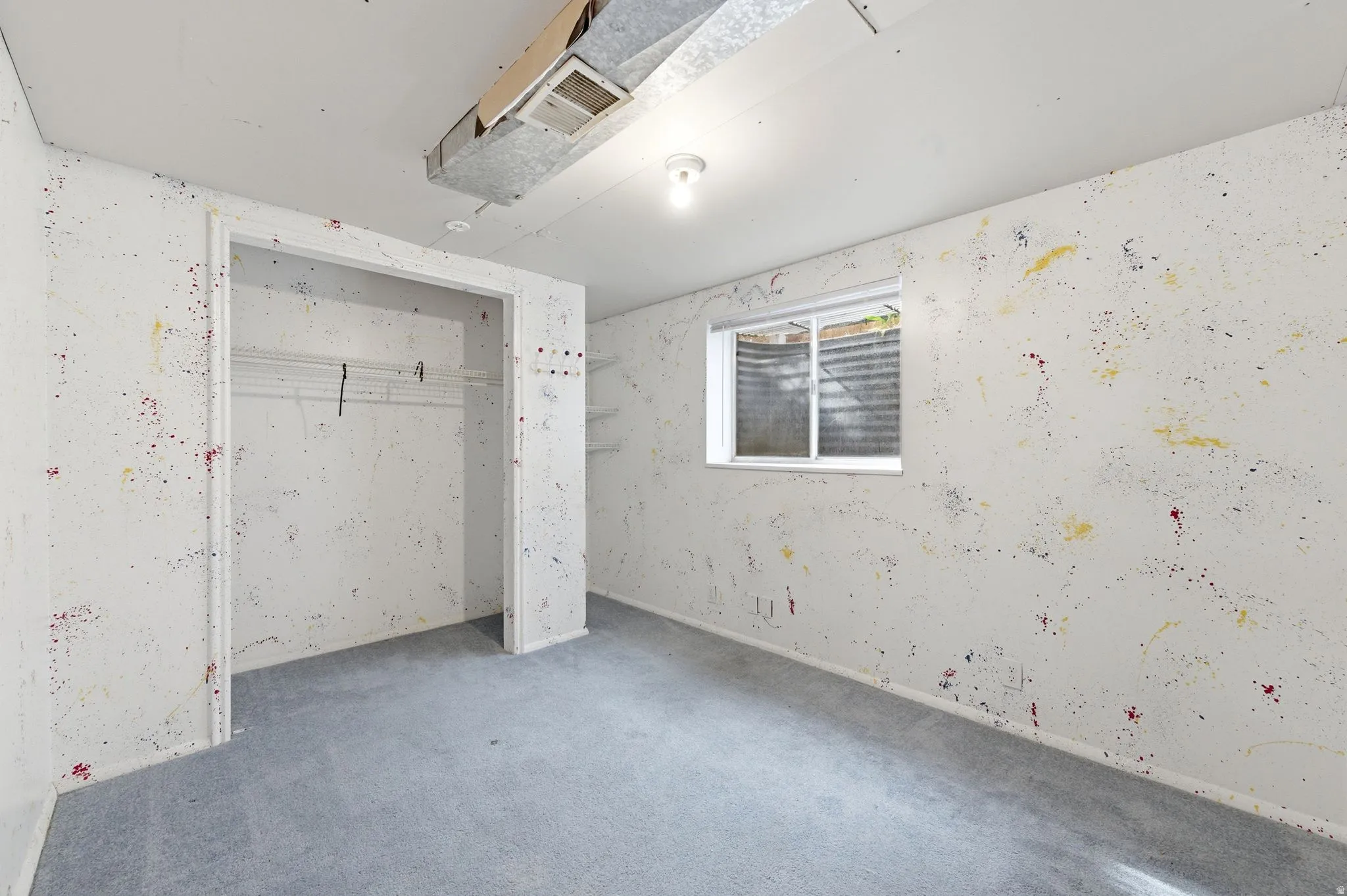 Unfurnished bedroom featuring wallpapered walls, a closet, and carpet