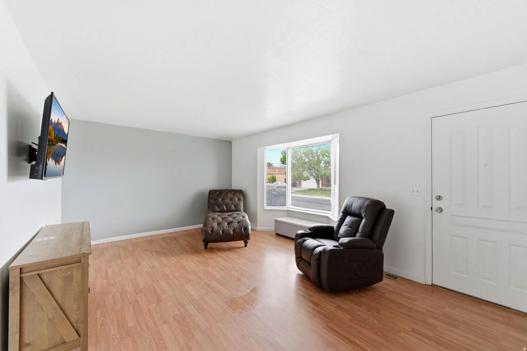 Living area featuring light wood finished floors and baseboards