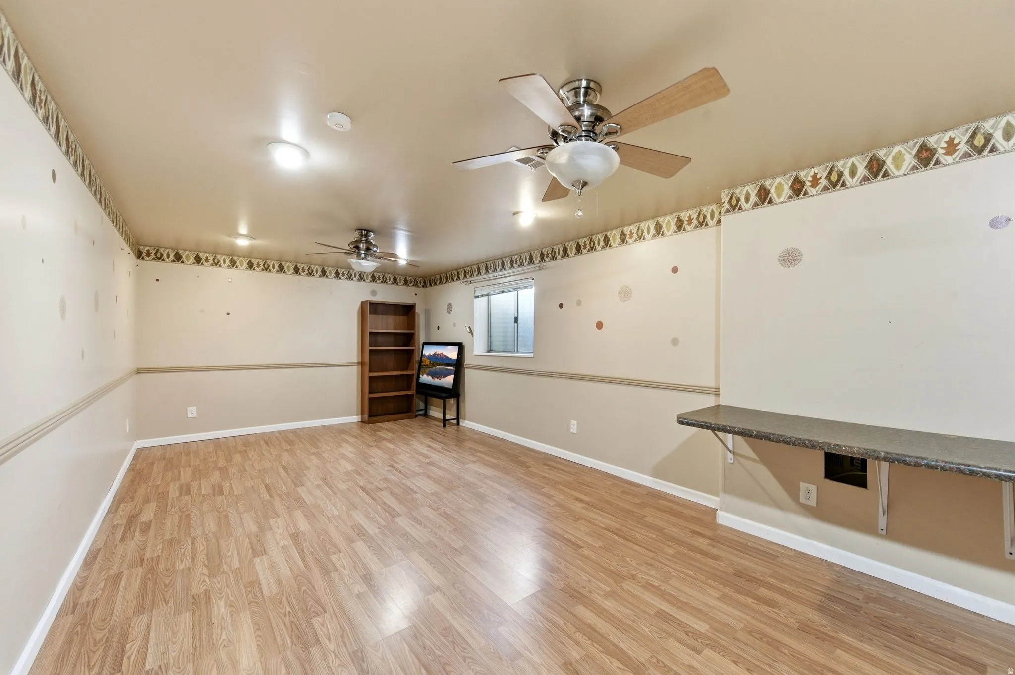 Spare room featuring light wood-style floors and ceiling fan