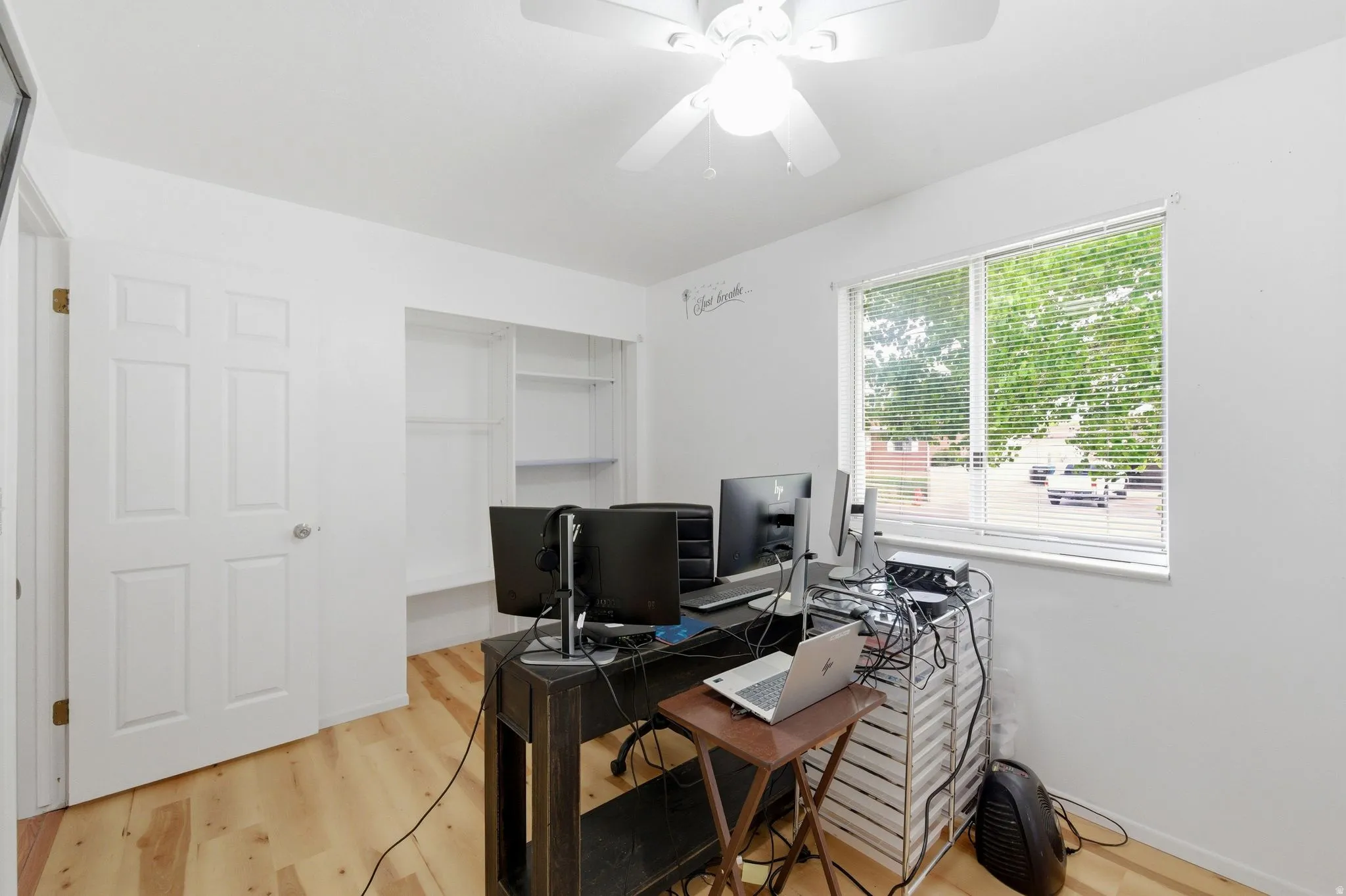 Office space featuring ceiling fan and light wood finished floors