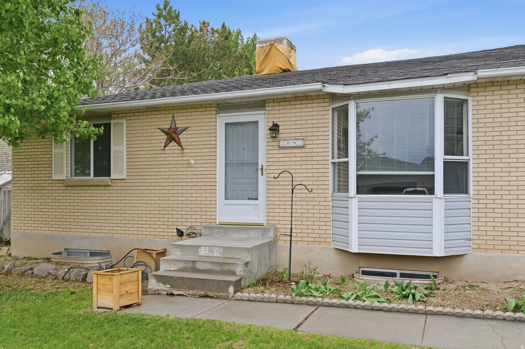 Entrance to property with brick siding and a chimney