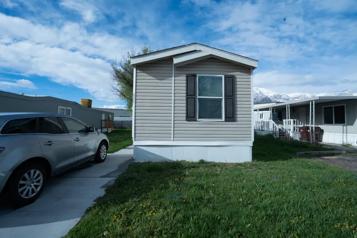 View of home's exterior featuring a yard and a mountain view