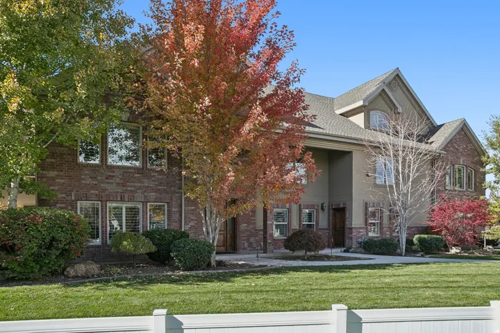 View of front of house with brick siding and stucco siding