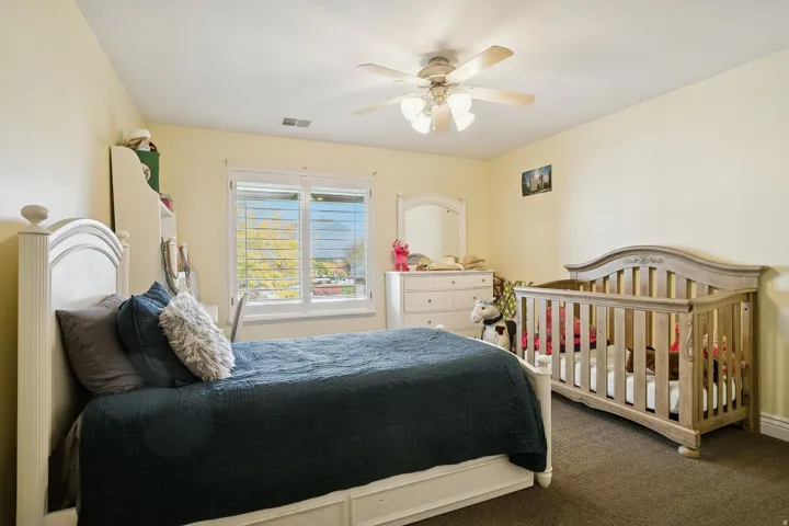 Bedroom with carpet and a ceiling fan