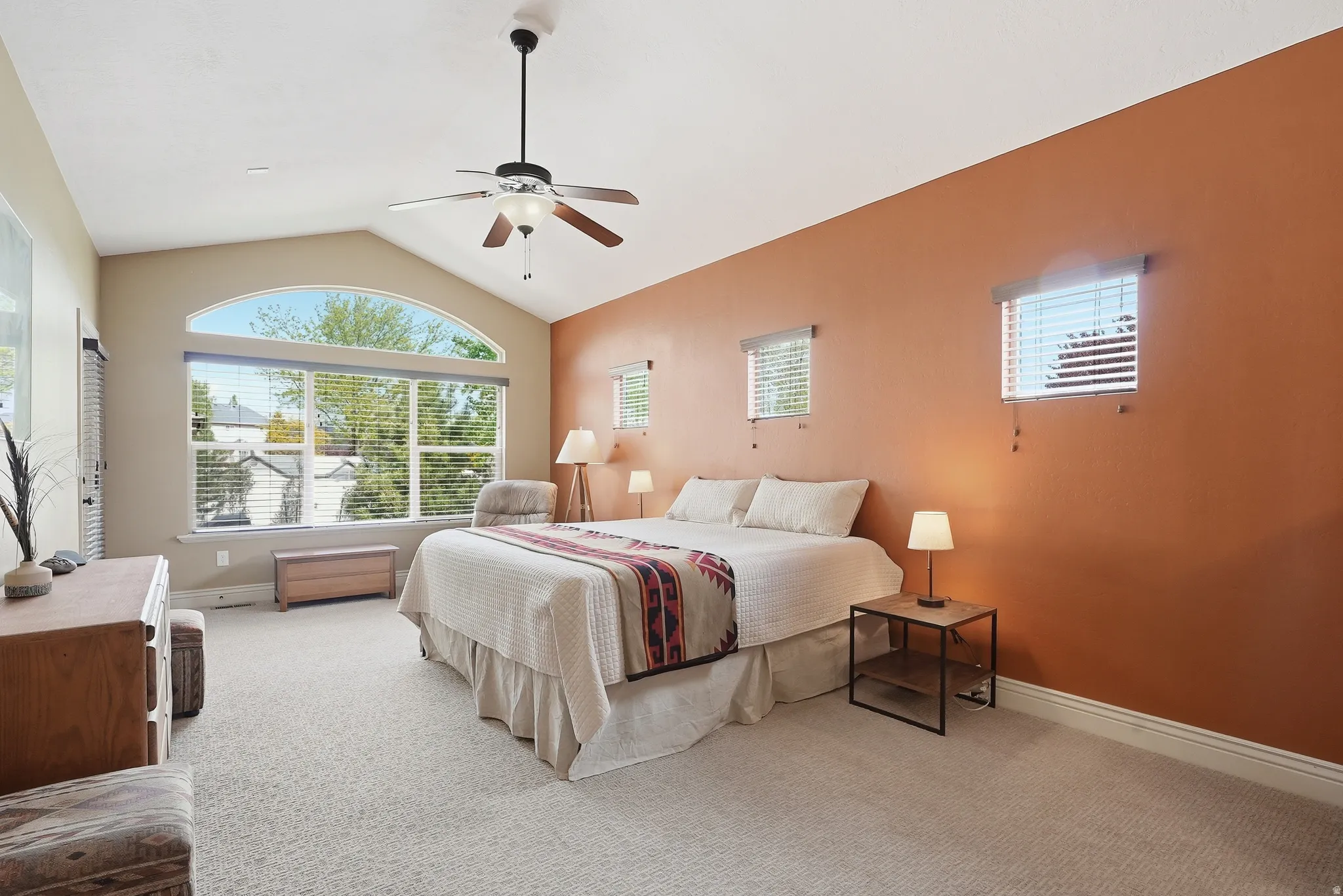 Huge primary bedroom with vaulted ceiling, lots of natural light and walk-out to yard