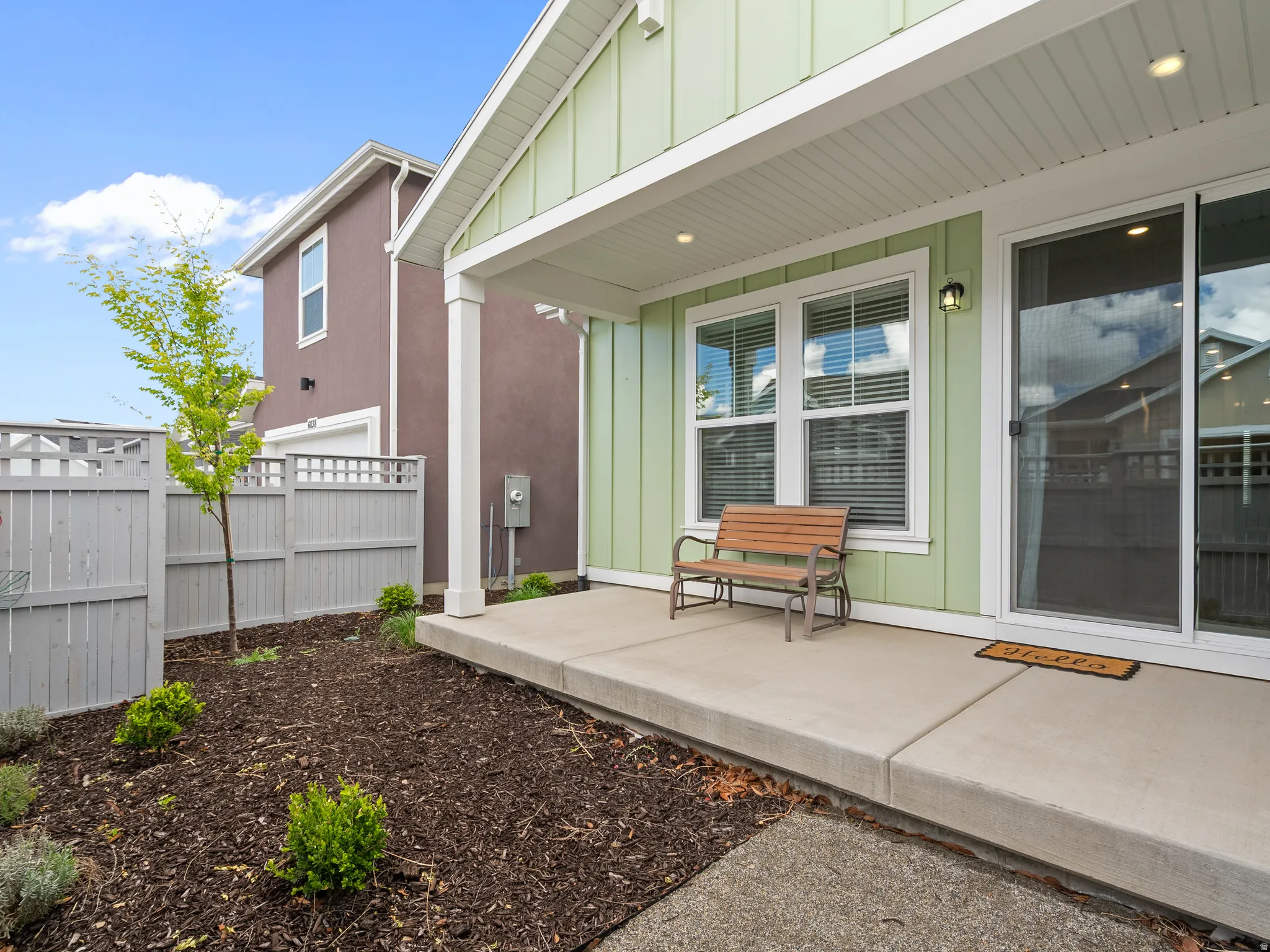 Doorway to property with board and batten siding and a porch