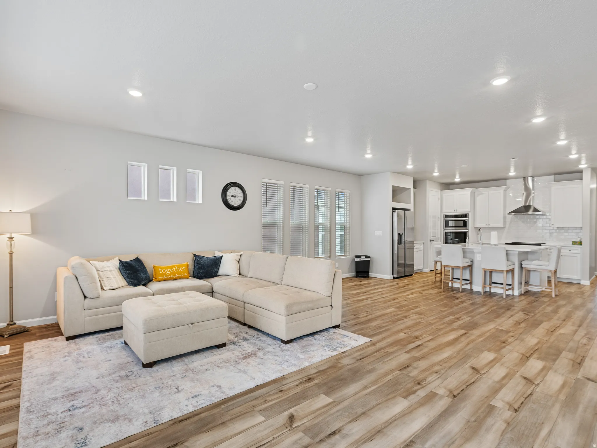 Living room featuring light wood-type flooring and recessed lighting