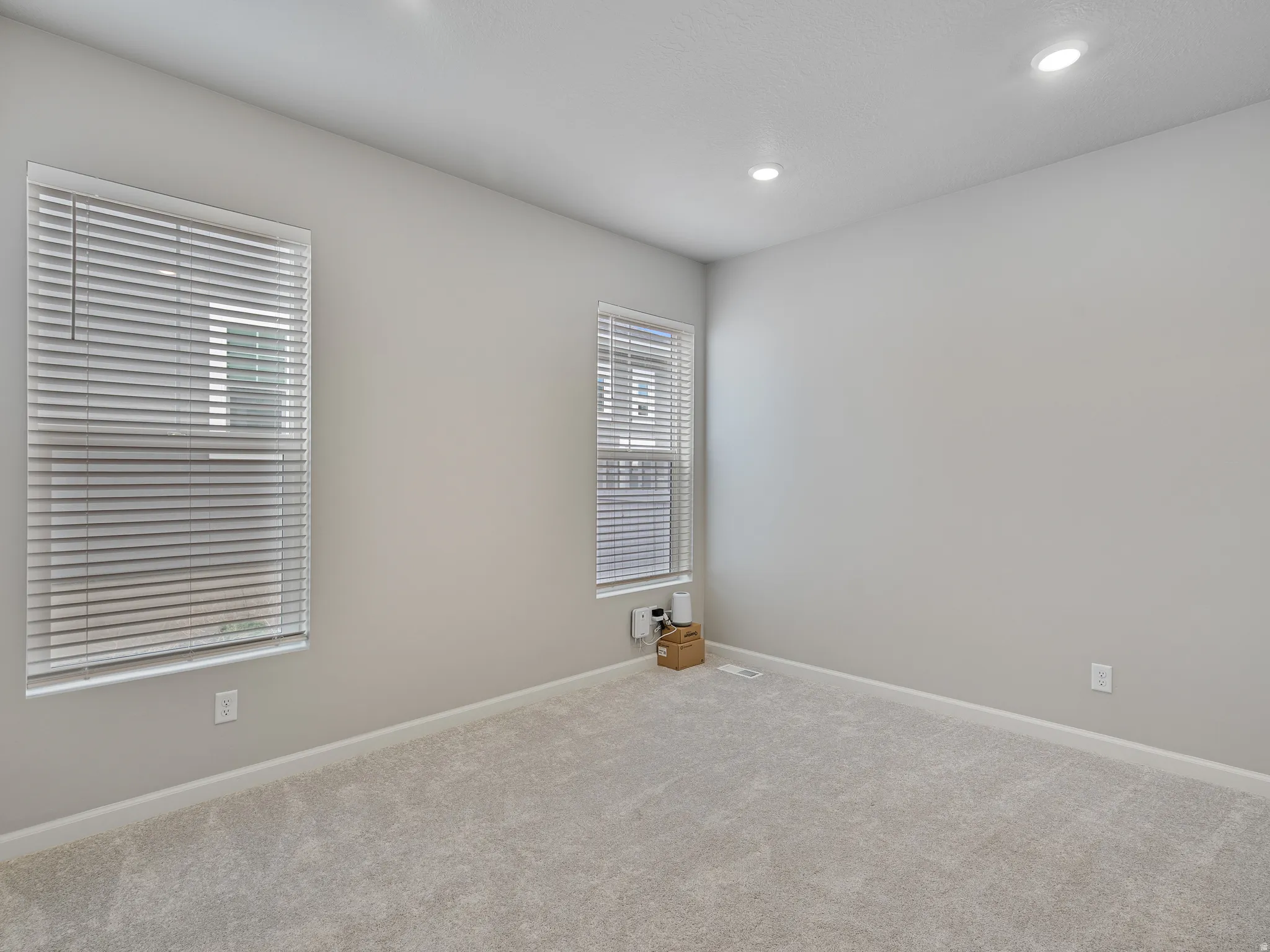 Spare room featuring carpet flooring and recessed lighting