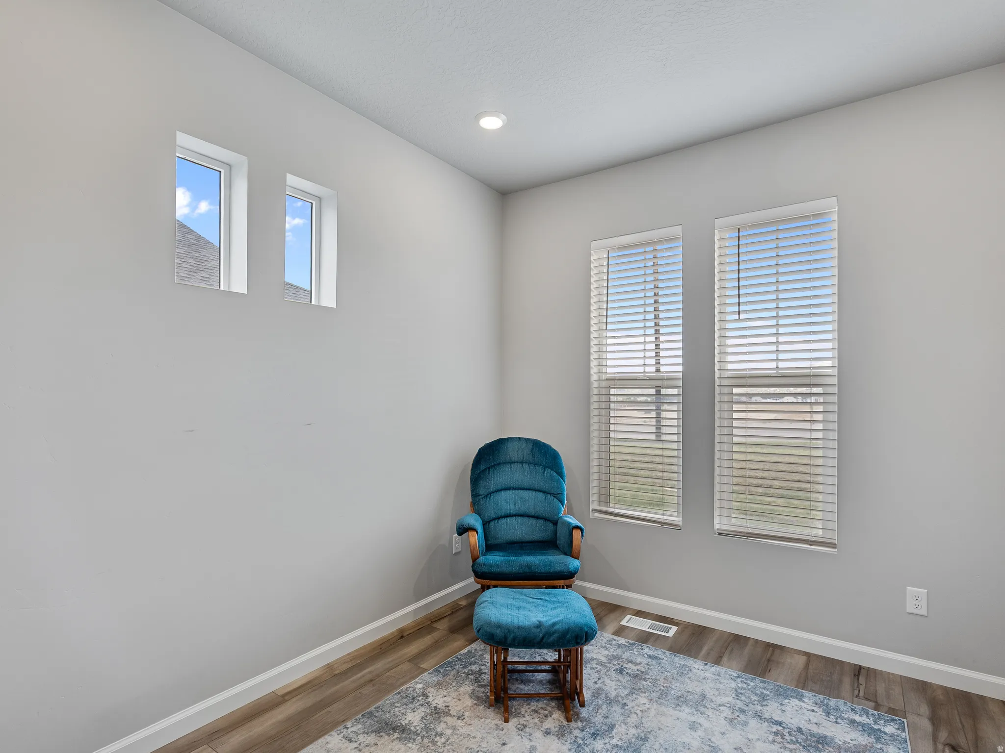 Living area featuring wood finished floors and recessed lighting