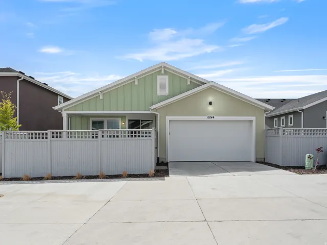 View of front of home featuring concrete driveway, an attached garage, and board and batten siding